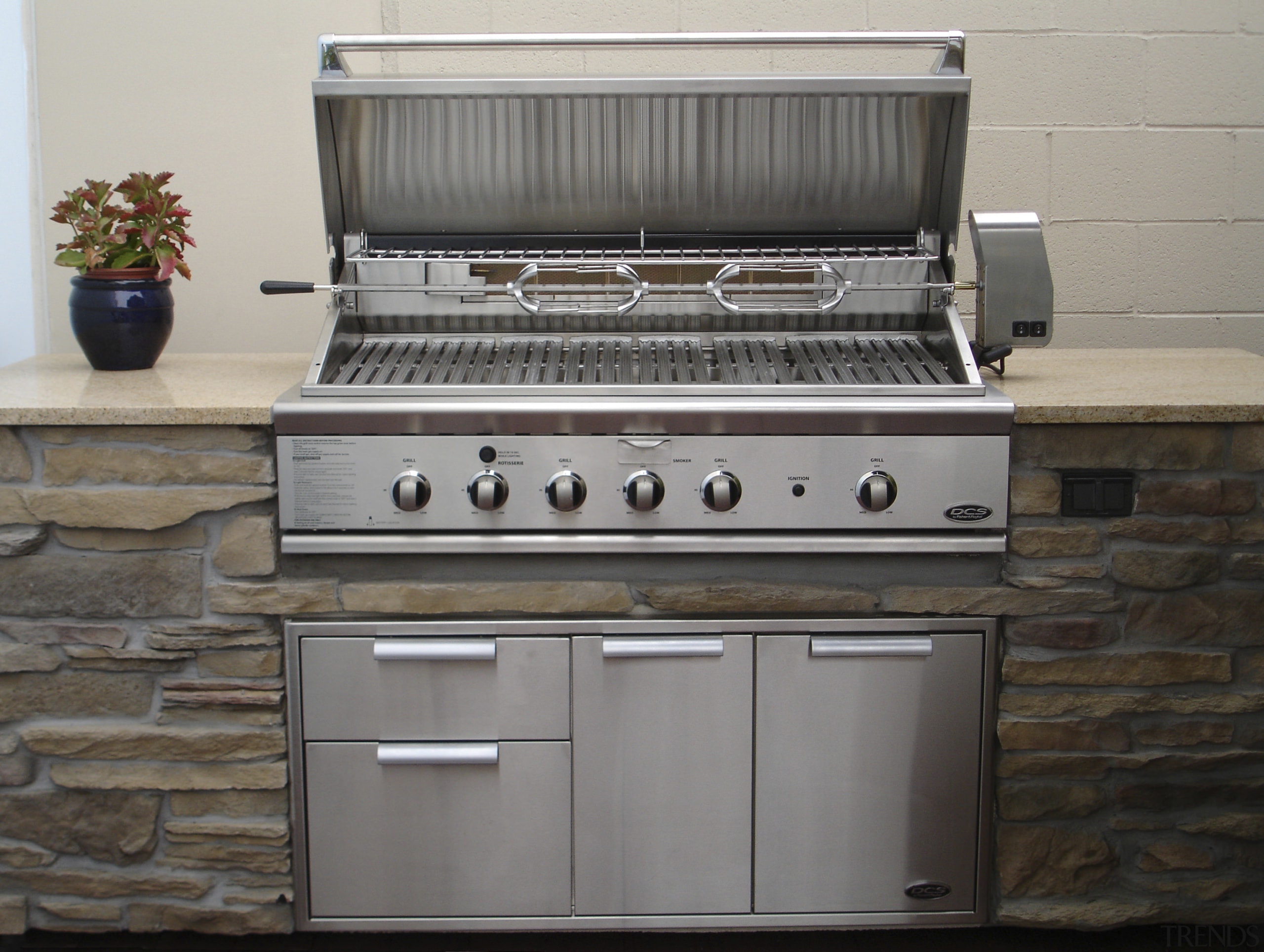 View of DCS outdoor cooking equipment by Fisher barbecue grill, gas stove, home appliance, kitchen appliance, kitchen stove, outdoor grill, outdoor grill rack & topper, gray, black