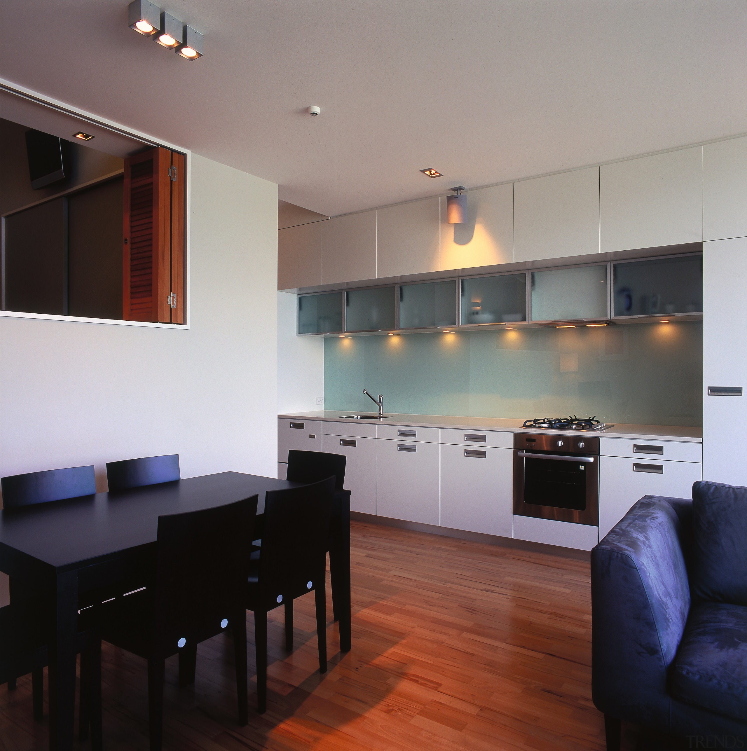 Apartment dining and kitchen area with timber flooring, architecture, ceiling, countertop, floor, flooring, hardwood, house, interior design, kitchen, living room, real estate, room, table, wood flooring, gray, black