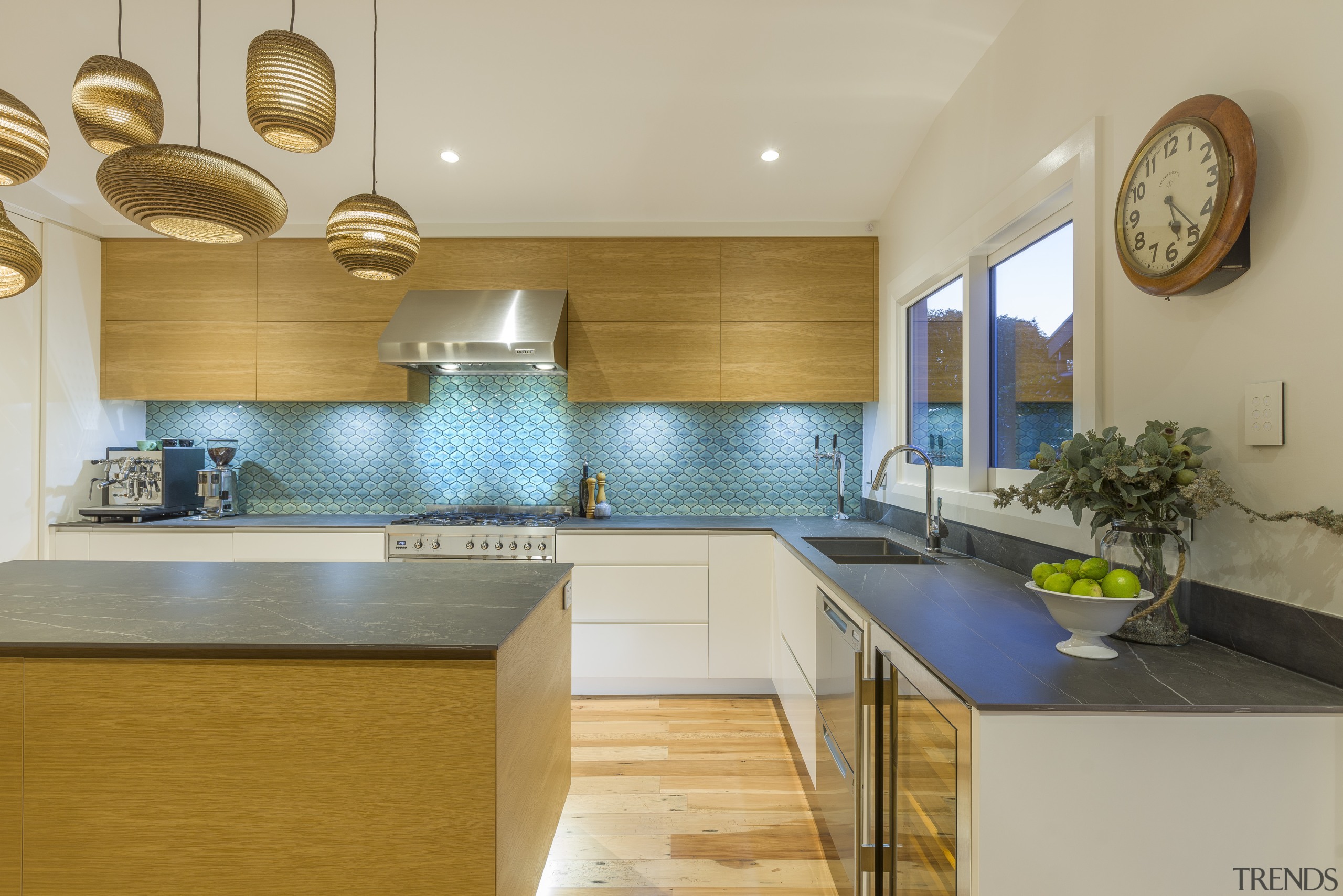 This sleek, contemporary kitchen includes touches like recessed architecture, building, cabinetry, ceiling, countertop, floor, flooring, furniture, hardwood, home, house, interior design, kitchen, kitchen stove, material property, property, real estate, room, sink, tile, yellow, gray, brown