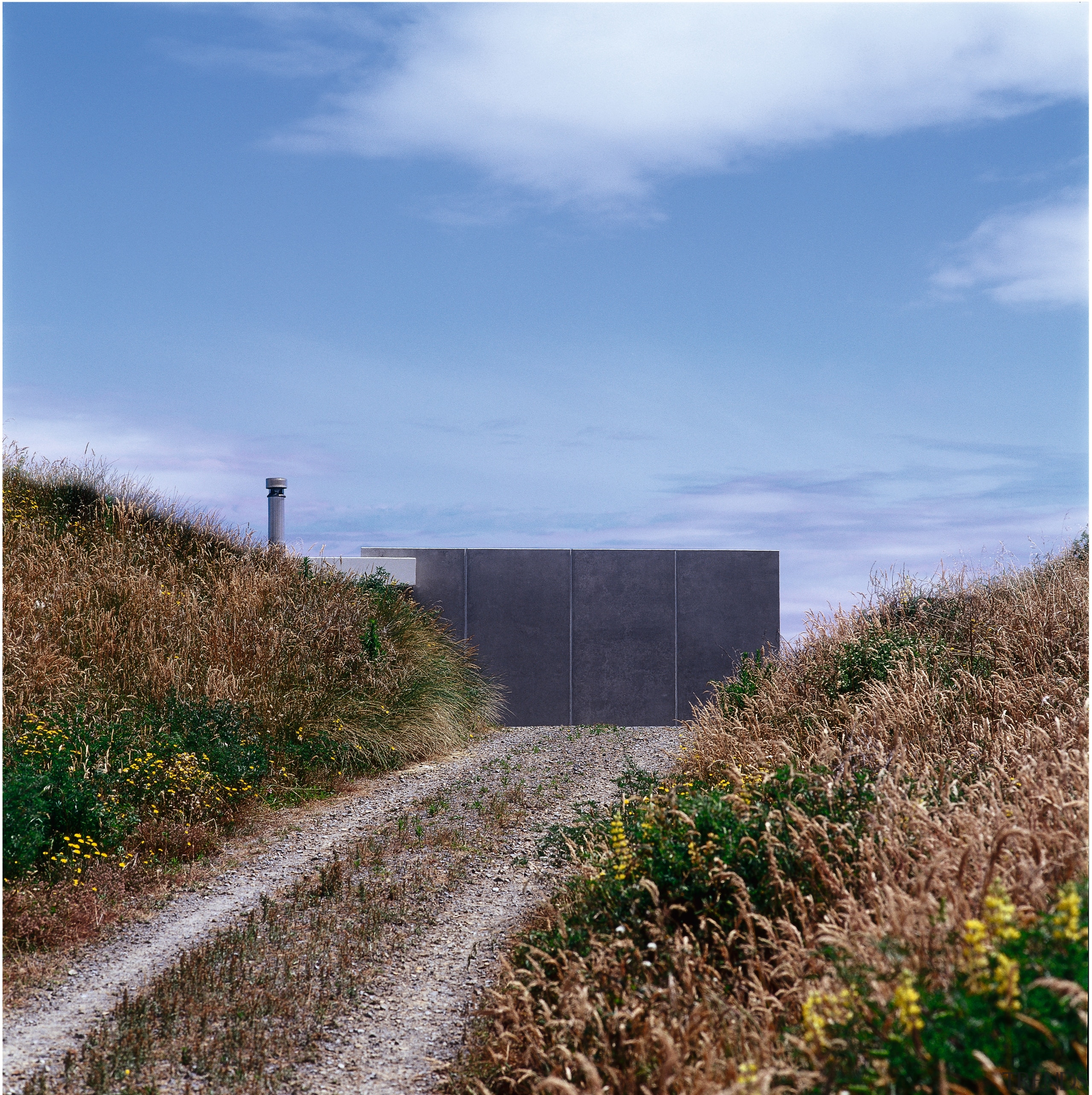 An exterior view of this holiday nestled amongst cloud, field, grass, grass family, land lot, prairie, road, rural area, sky, teal, brown