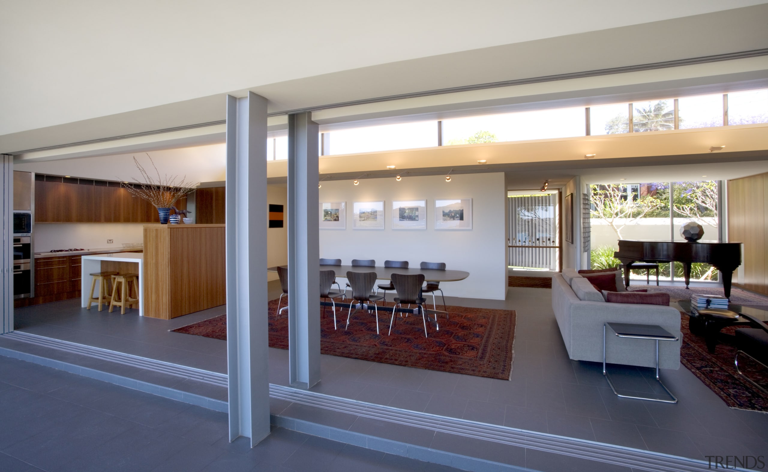 The entrance way is to the left of architecture, door, house, interior design, living room, real estate, window, gray