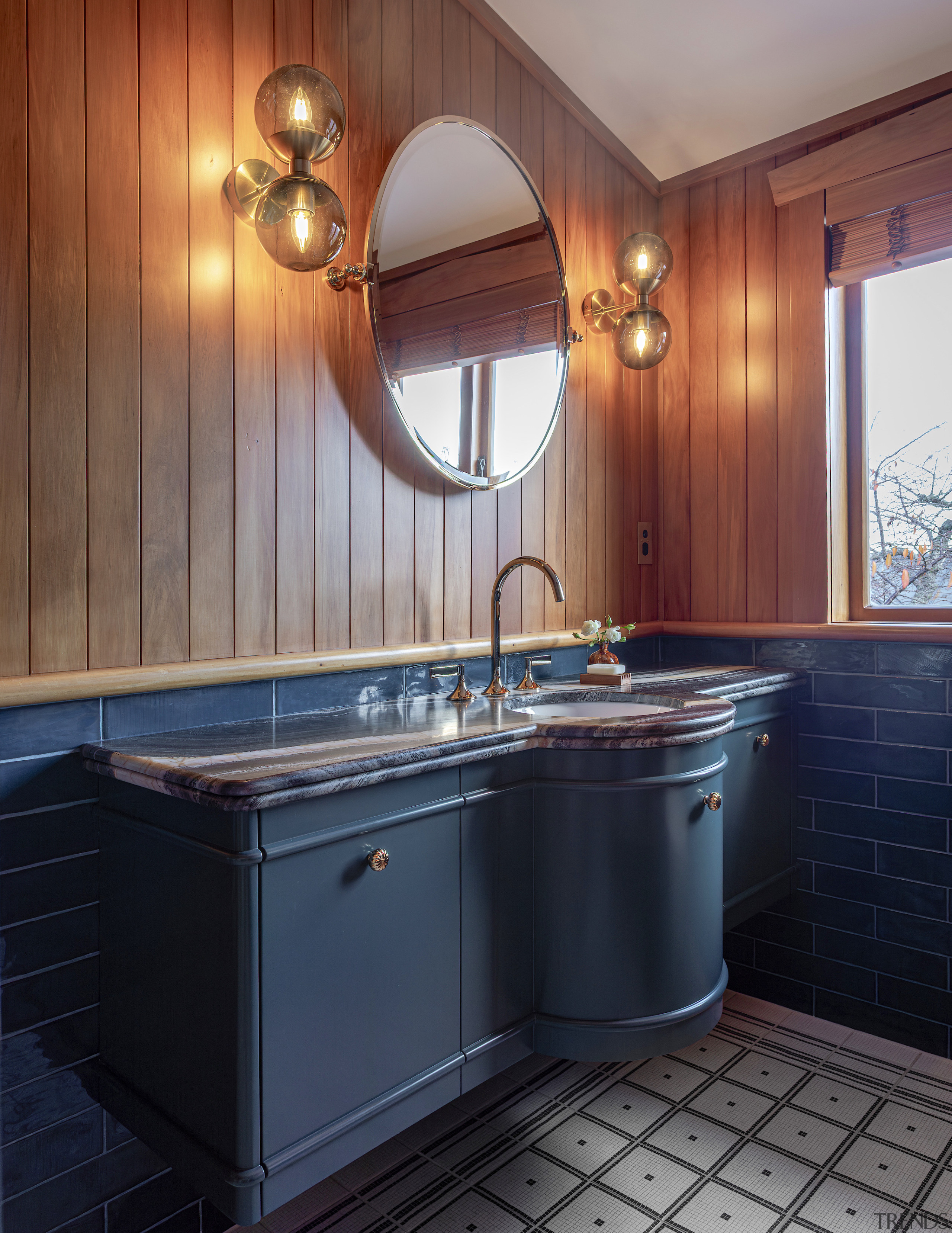 A round mirror reminiscent of a porthole bounces 