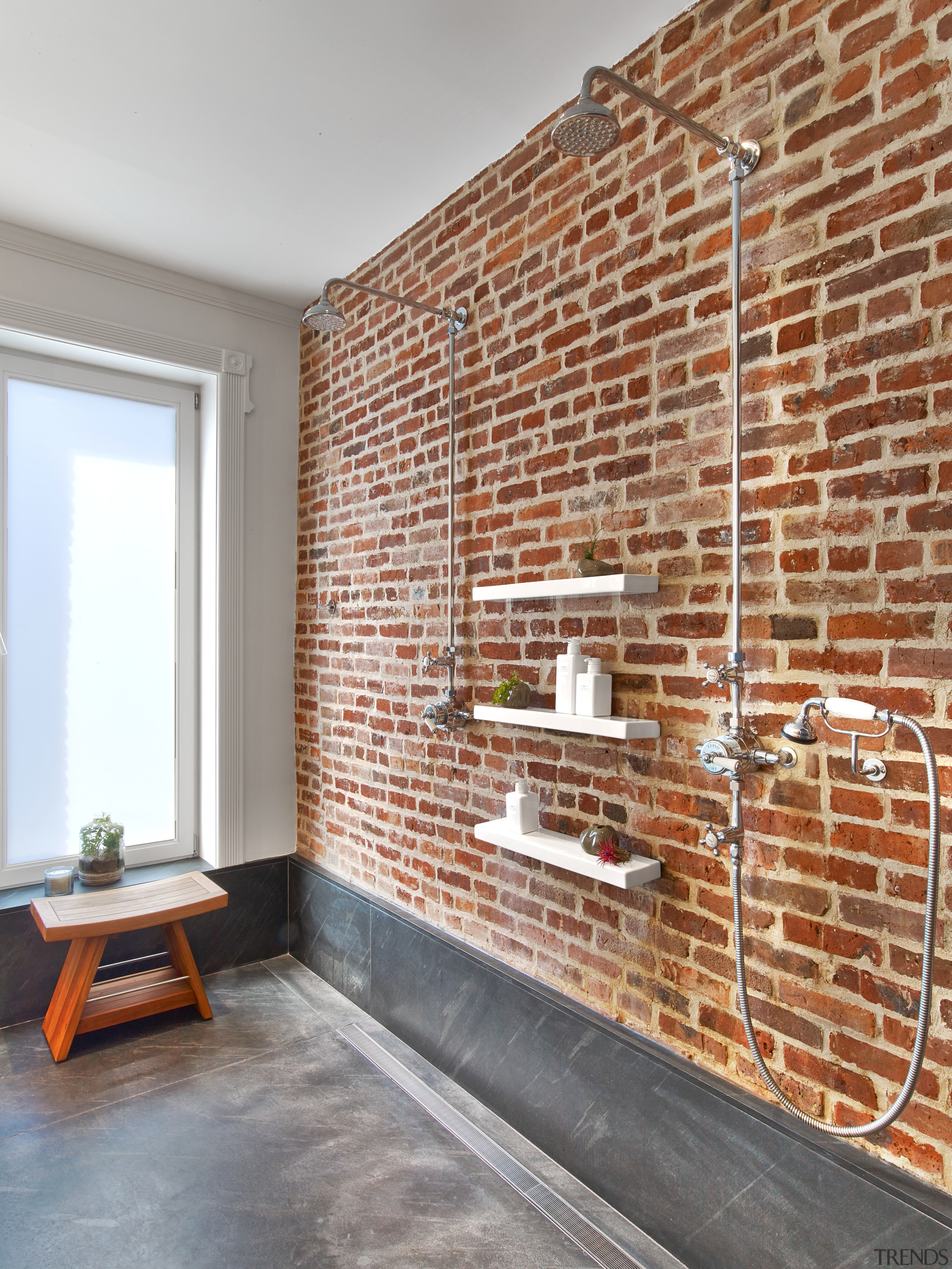 An original brick wall was exposed and sealed brick, brickwork, floor, flooring, interior design, real estate, wall, gray, brown