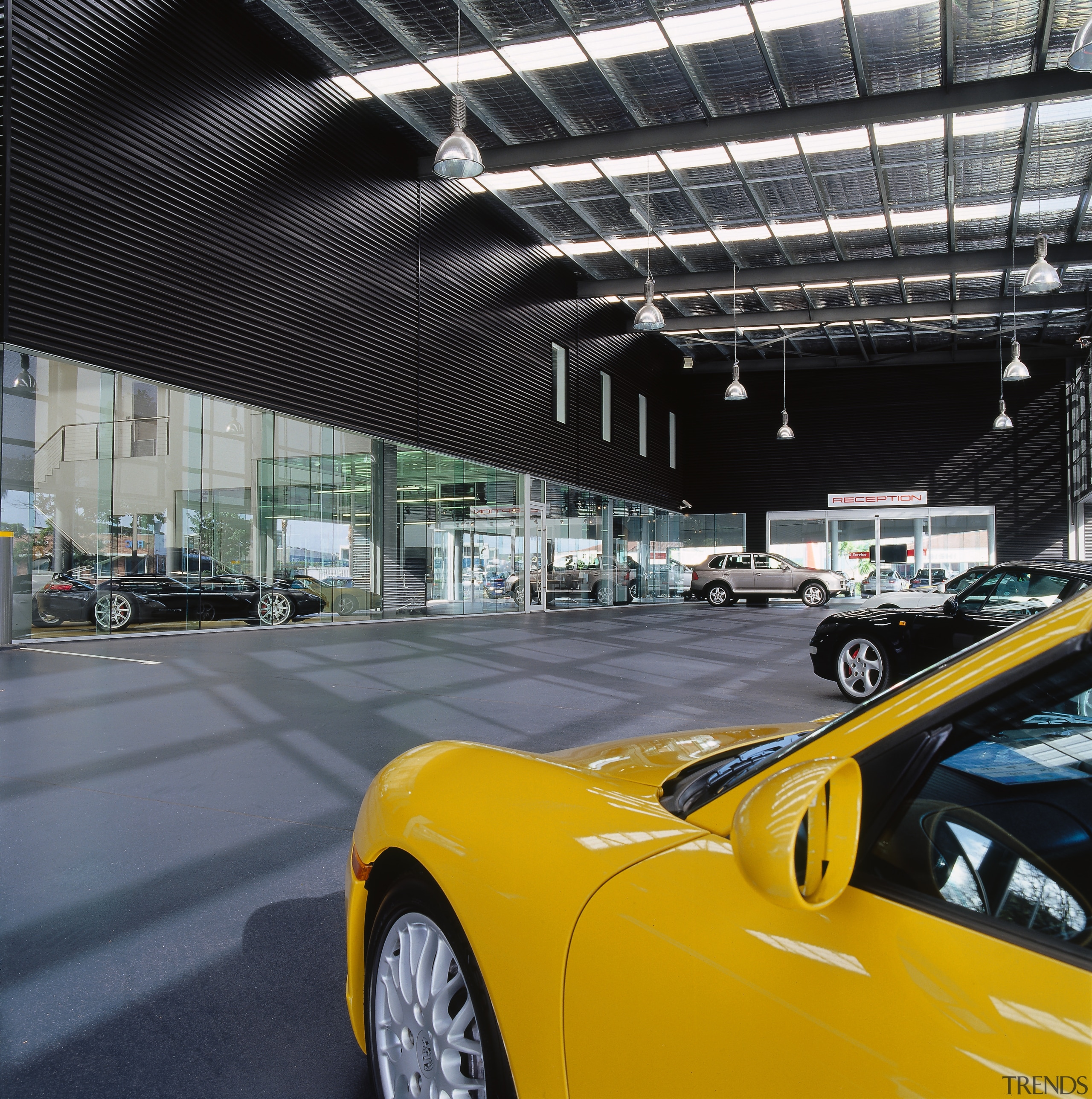 view of the canopy looking into the showroom, auto show, automotive design, automotive exterior, car, land vehicle, luxury vehicle, motor vehicle, performance car, sports car, supercar, vehicle, yellow, black, gray