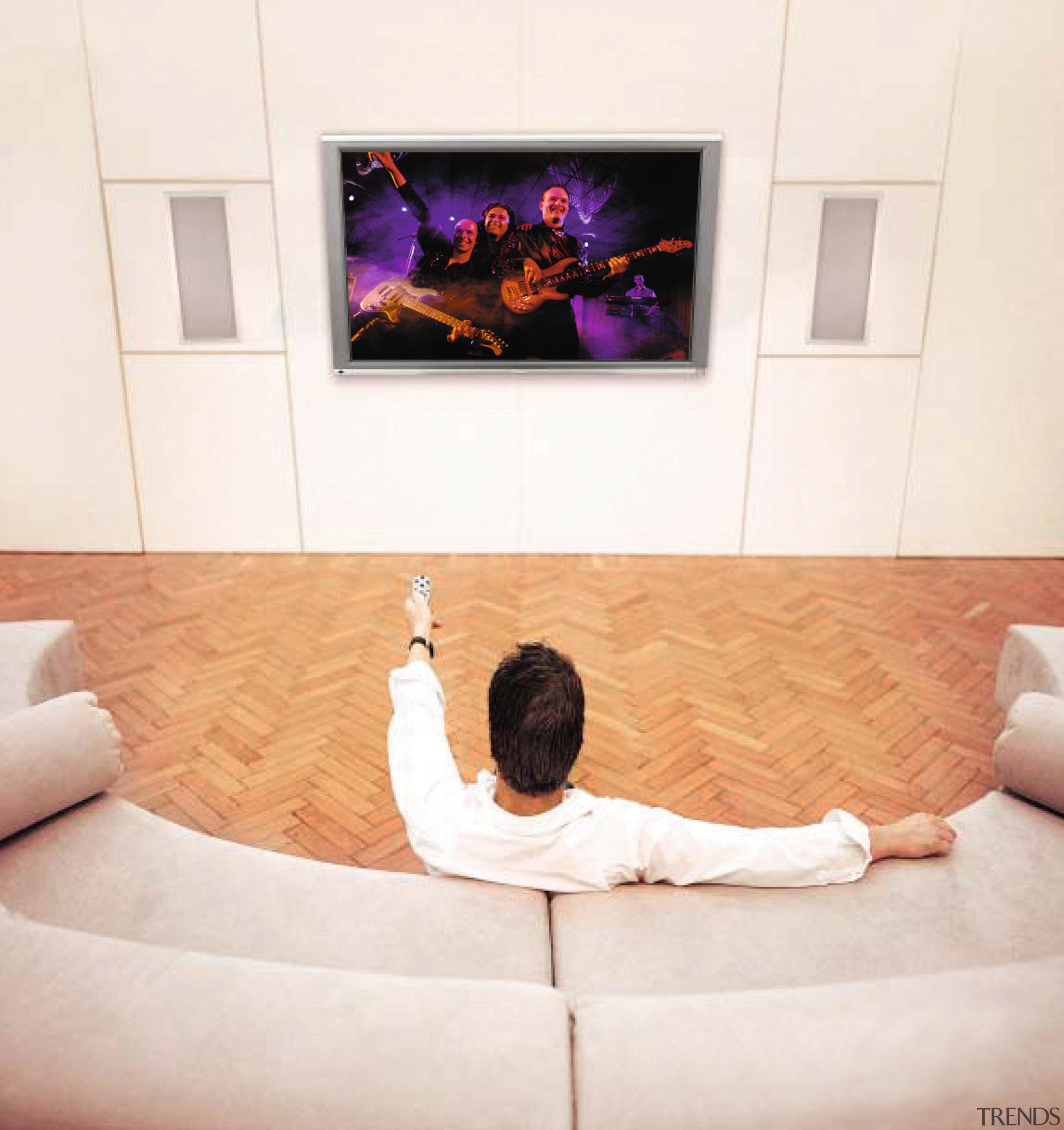 A photograph of a home theatre system featuring couch, floor, flooring, furniture, interior design, media, room, television, wall, white