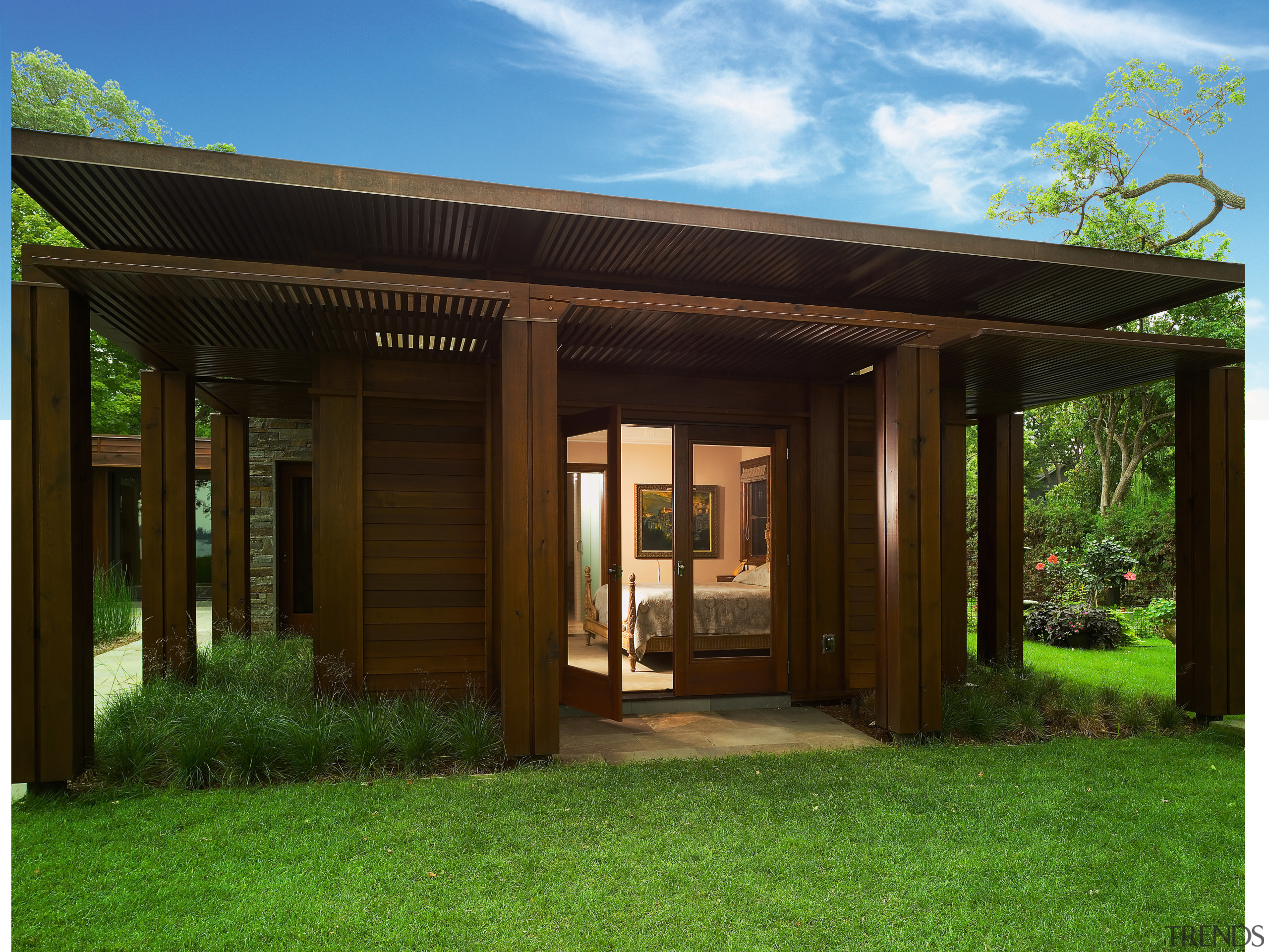 An exterior view of the home. - An backyard, cottage, estate, facade, grass, home, house, outdoor structure, property, real estate, roof, shed, yard, brown