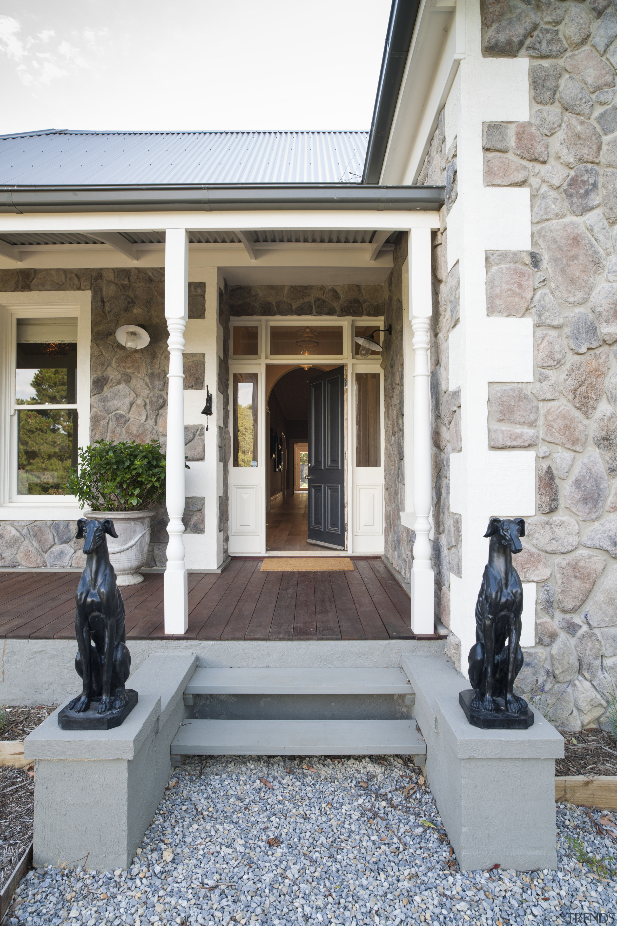 A central hallway provides a vista right through facade, house, window, white, gray