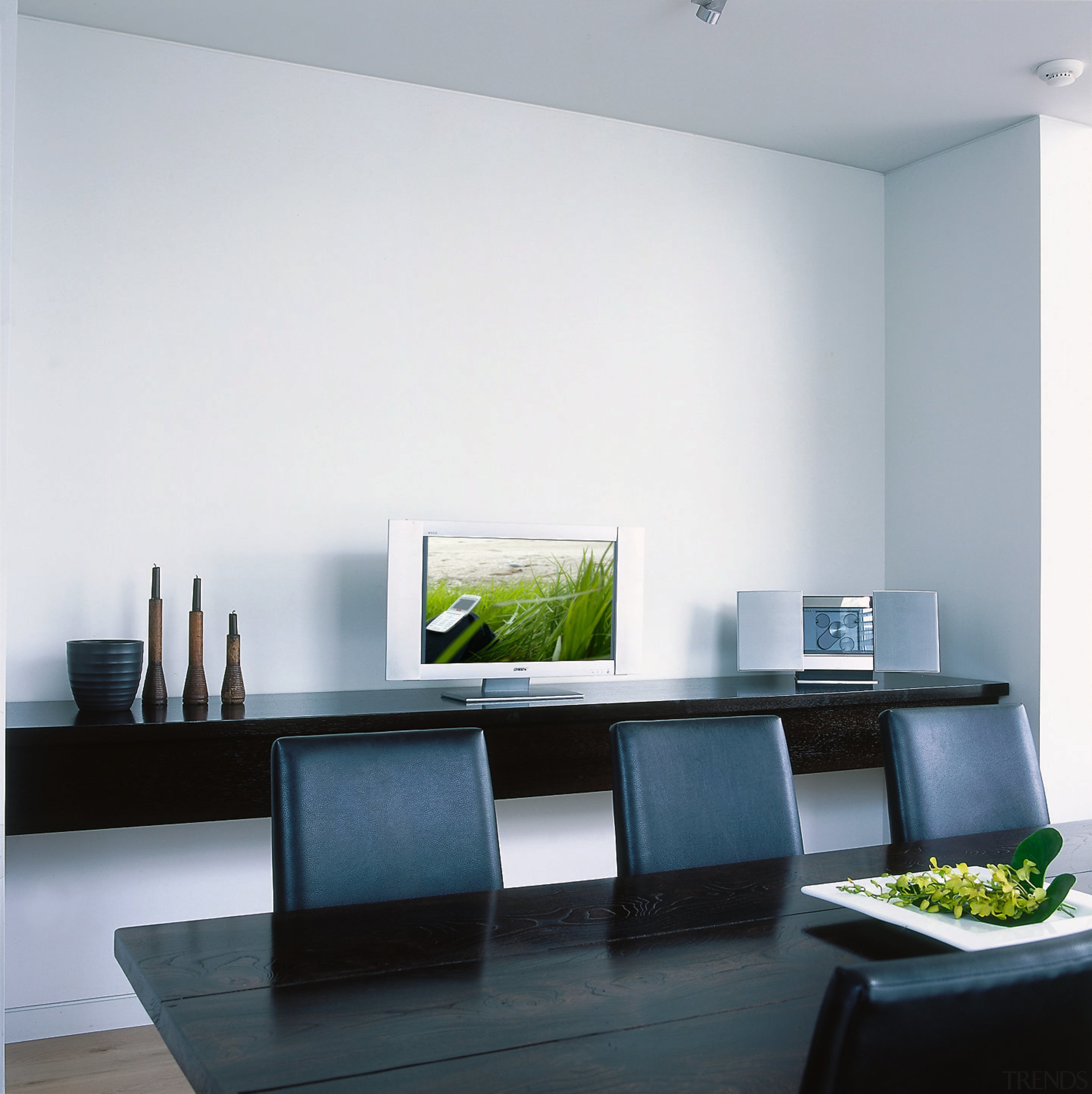 A photograph of a dining room featuring a desk, furniture, interior design, living room, office, product design, table, white