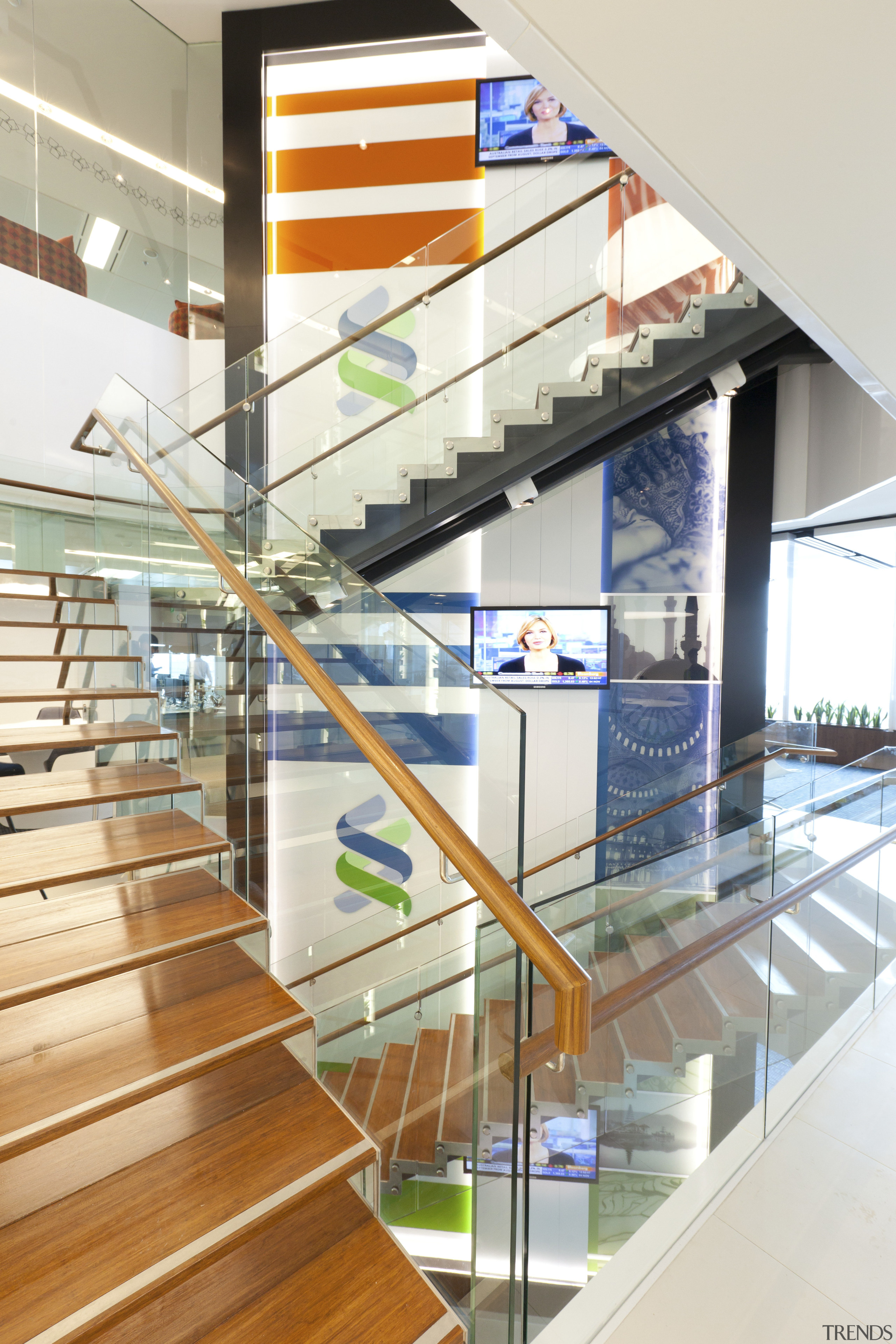 View of a contemporary corporate space with decorative architecture, daylighting, glass, handrail, interior design, stairs, white