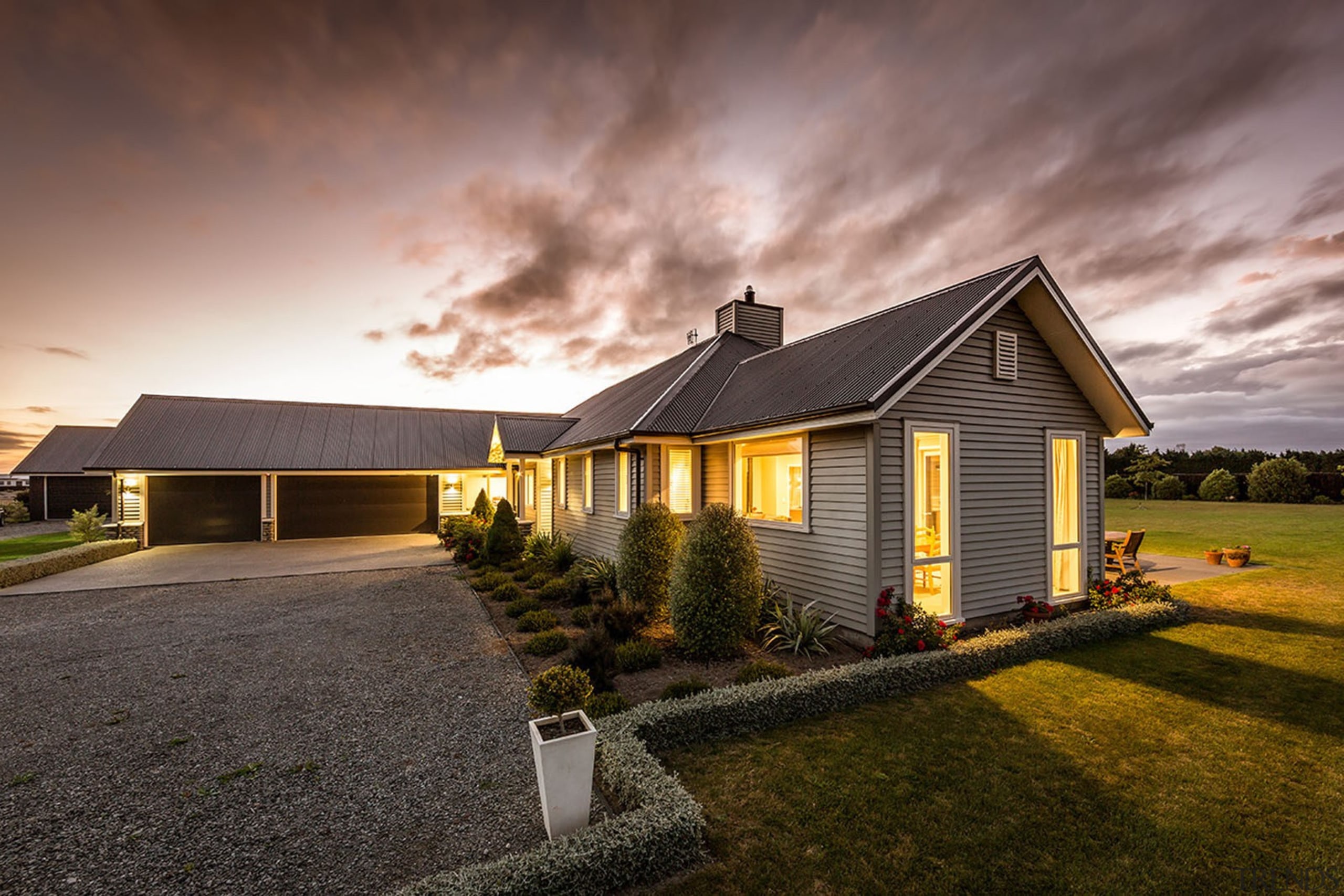 Built to last the test of time, this cloud, cottage, estate, evening, facade, farmhouse, grass, home, house, landscape, property, real estate, residential area, roof, sky, suburb, sunlight, gray
