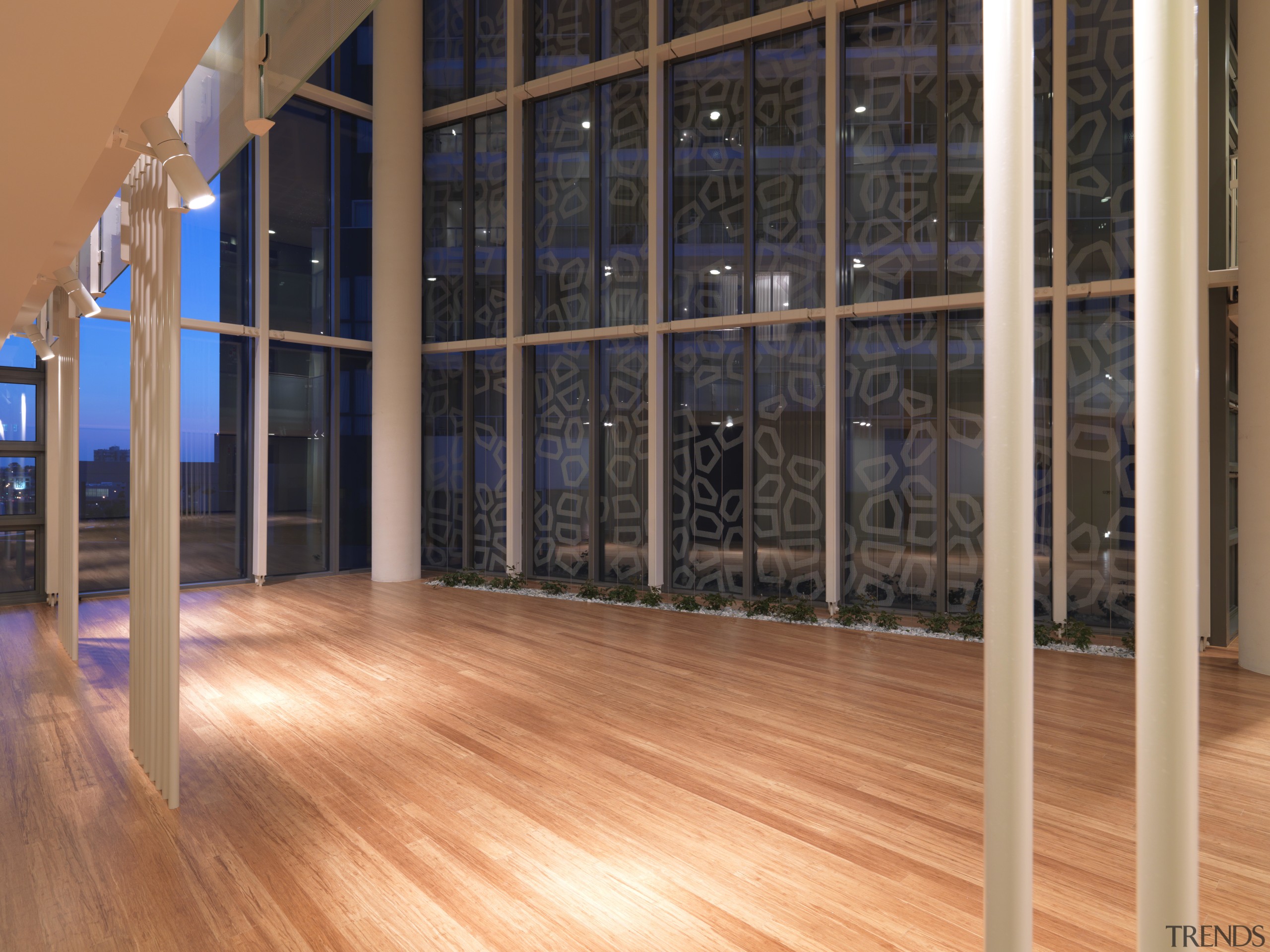 Interior view of the atrium of the Triptych floor, flooring, glass, hardwood, interior design, laminate flooring, real estate, wall, window, wood, wood flooring, orange, black