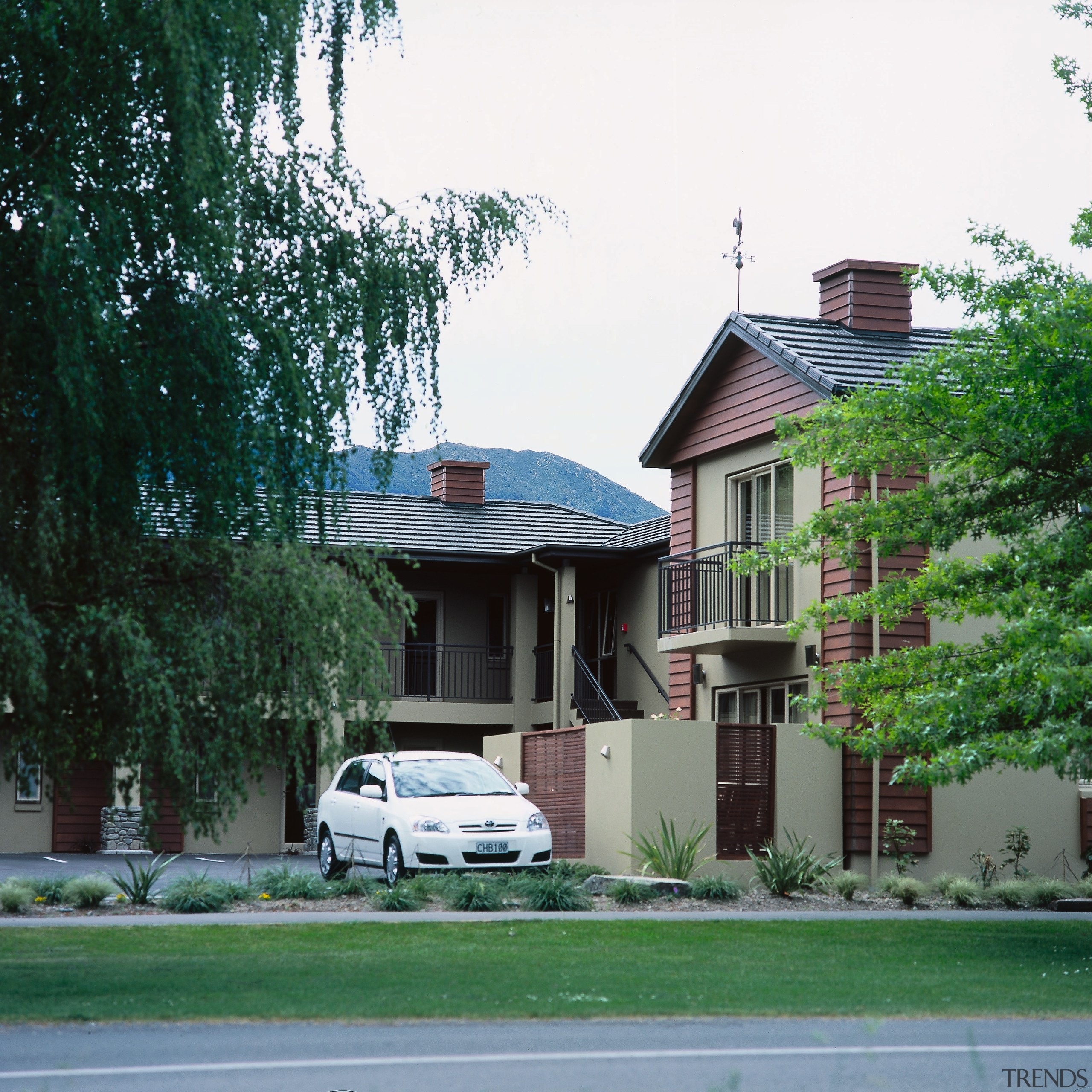 Exterior view of motor lodge with grey roofing architecture, building, car, cottage, estate, facade, home, house, mansion, neighbourhood, plant, property, real estate, residential area, roof, suburb, tree