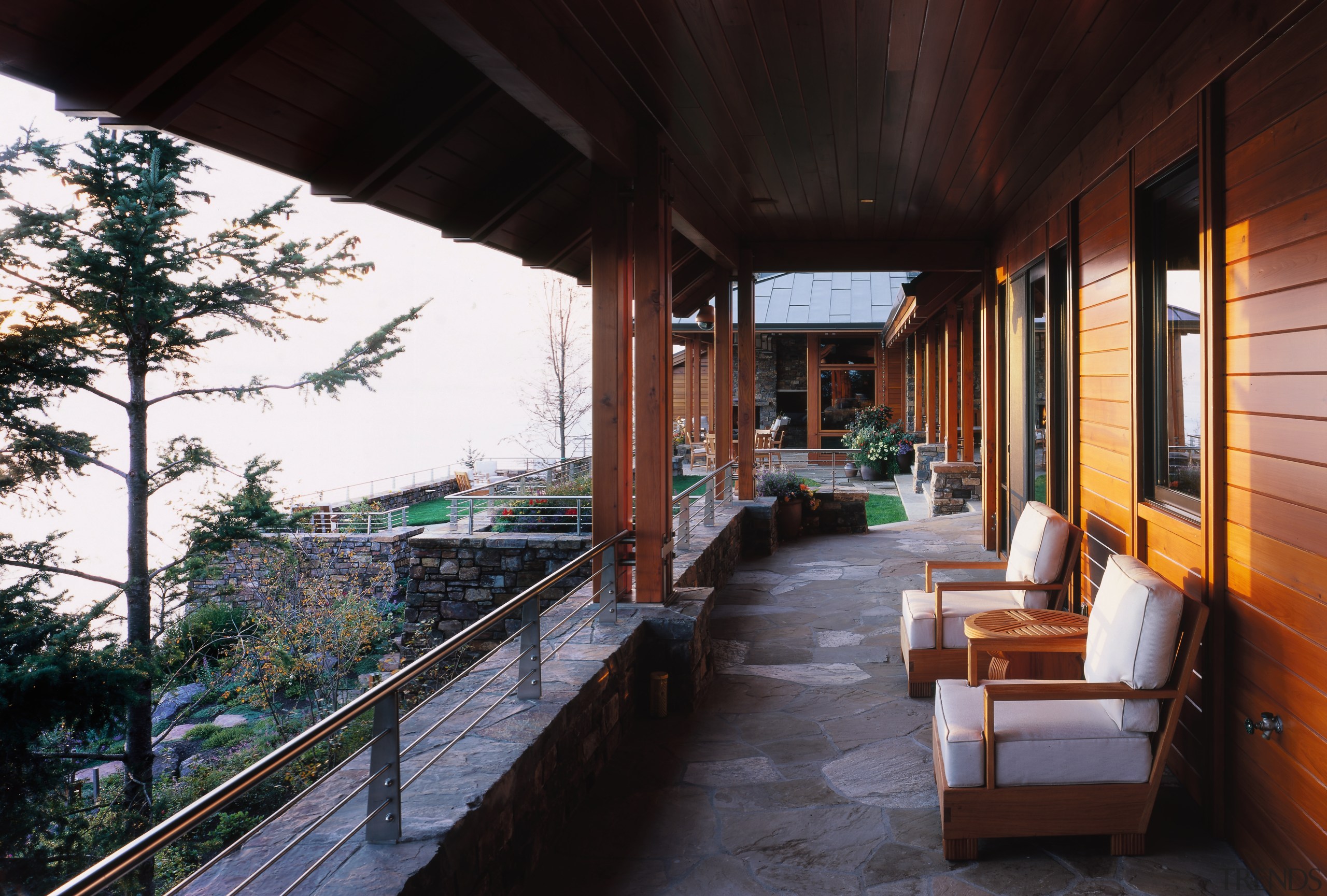 Exterior balcony area, stone pavers and wall, wooden balcony, estate, home, house, property, real estate, black