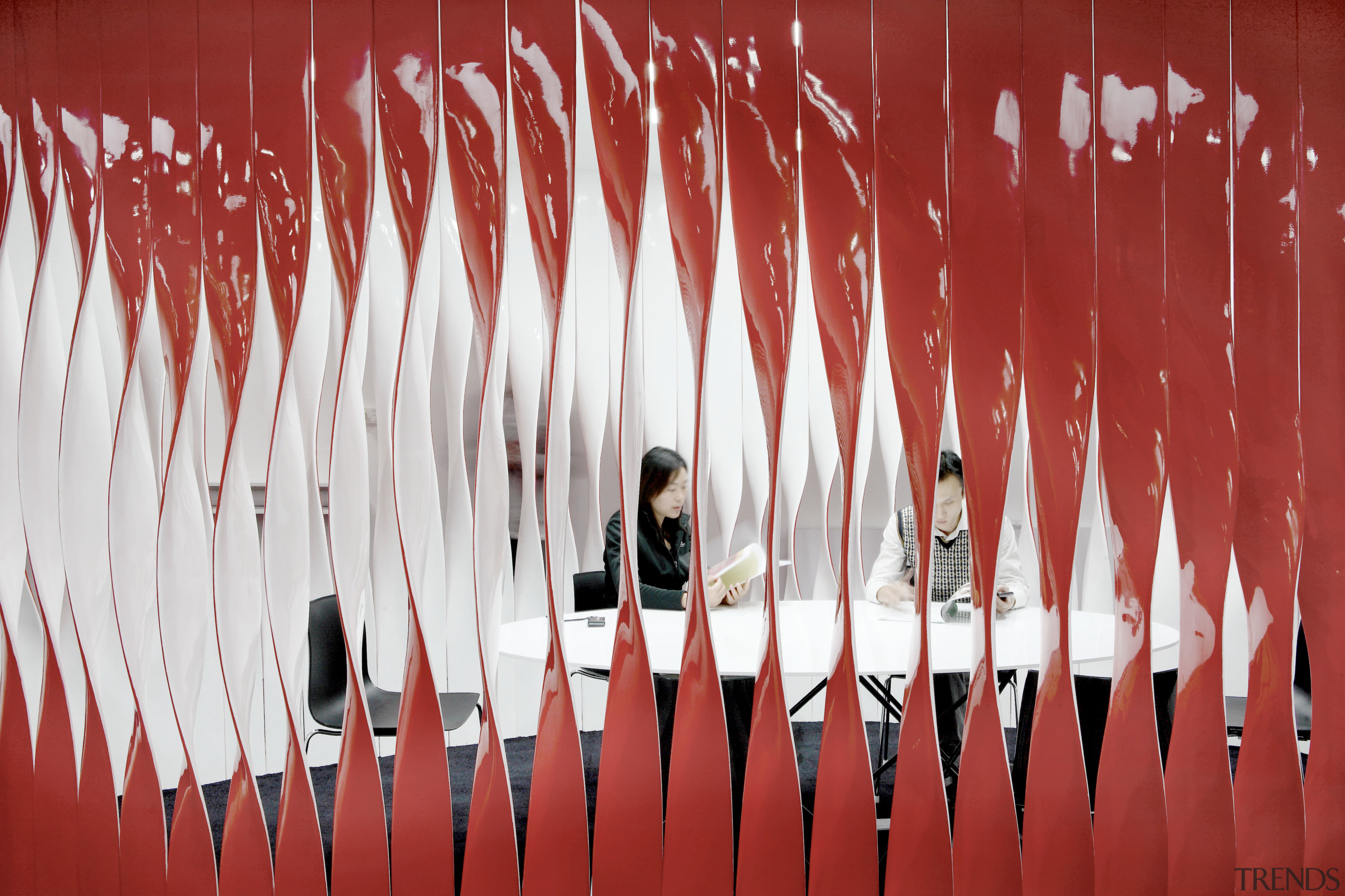 The Swissnex Shanghai office eatures twisted resin strips, line, red, red