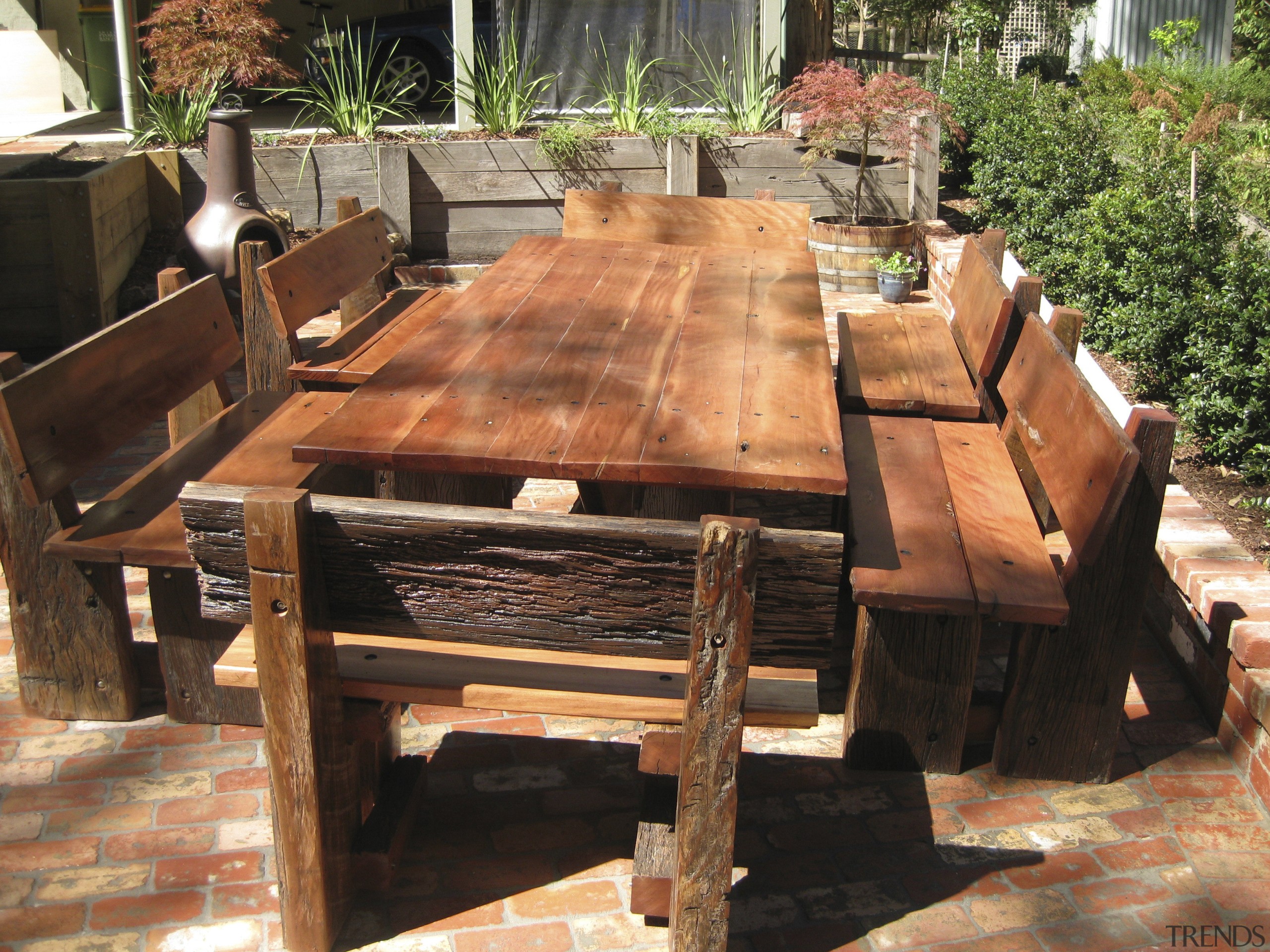 View of an outdoor area which features outdoor furniture, outdoor structure, table, wood, black, orange