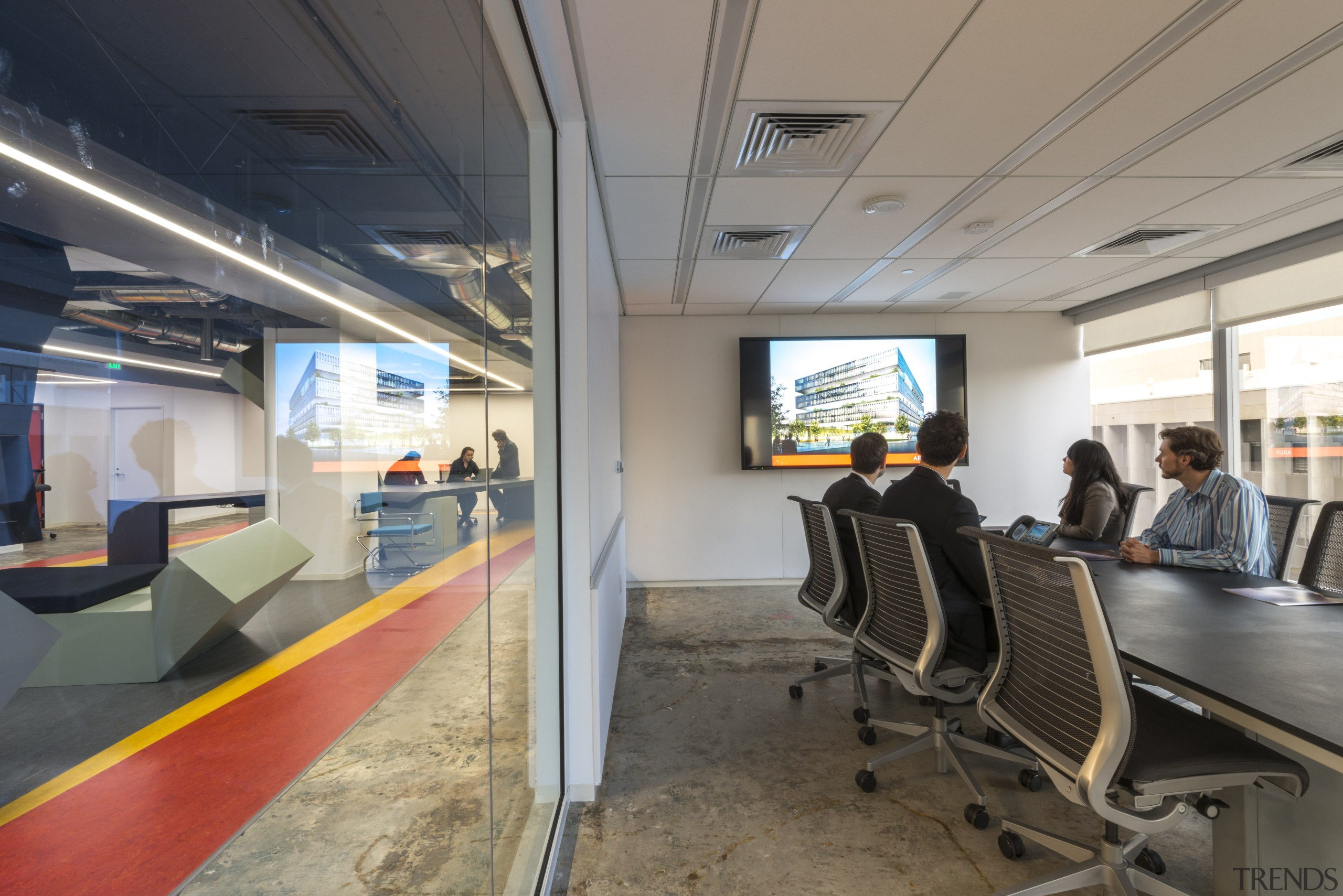 Glass walls separate the meeting rooms from the office, passenger, gray