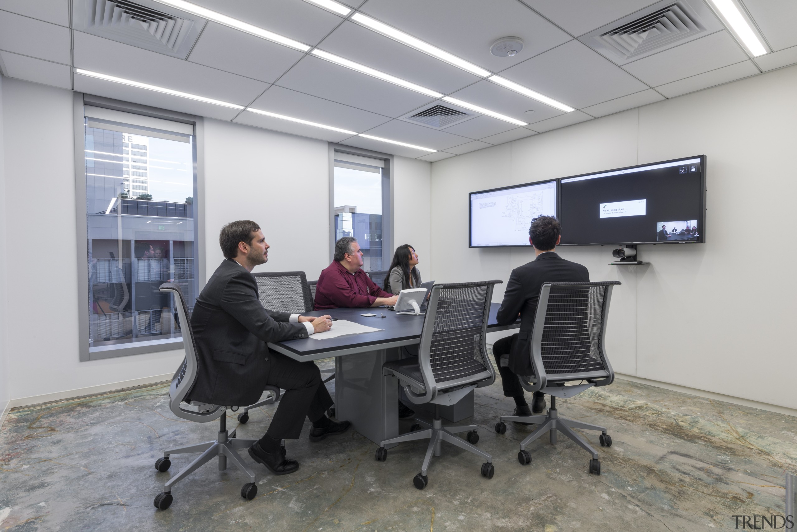 A trapezoidal table in the video-conferencing room of electronic device, institution, office, technology, gray