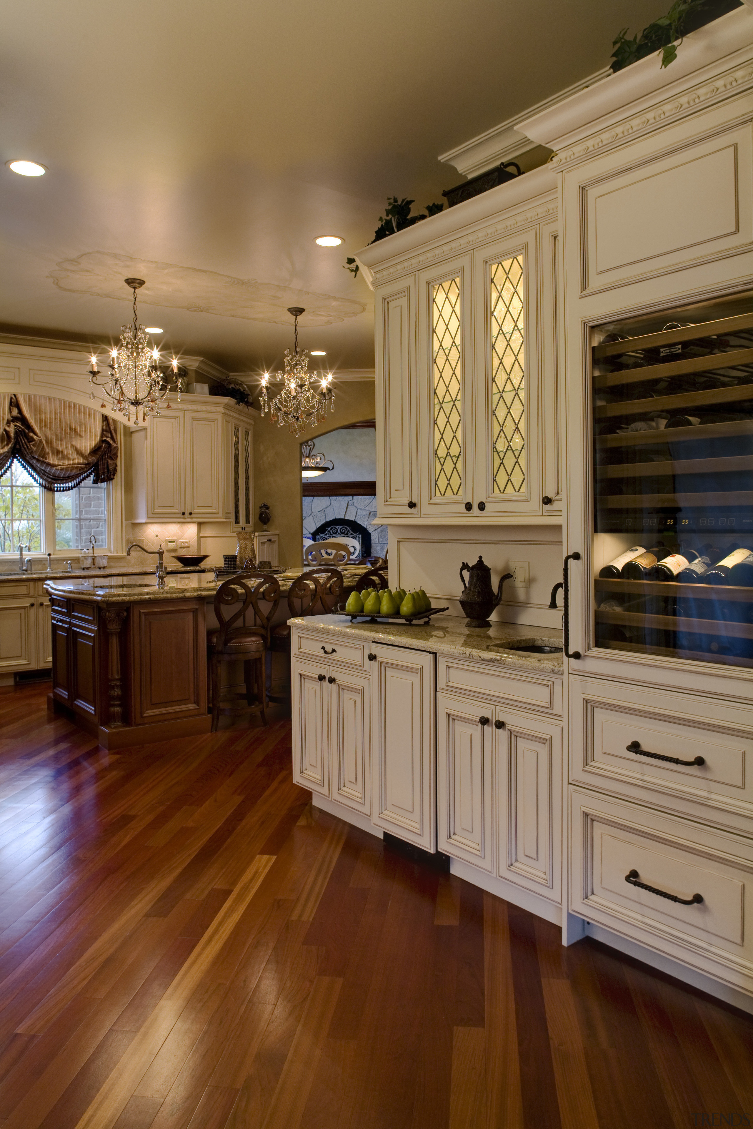 View of a kitchen which is centrally located cabinetry, countertop, cuisine classique, floor, flooring, hardwood, home, interior design, kitchen, laminate flooring, room, wood, wood flooring, brown, orange