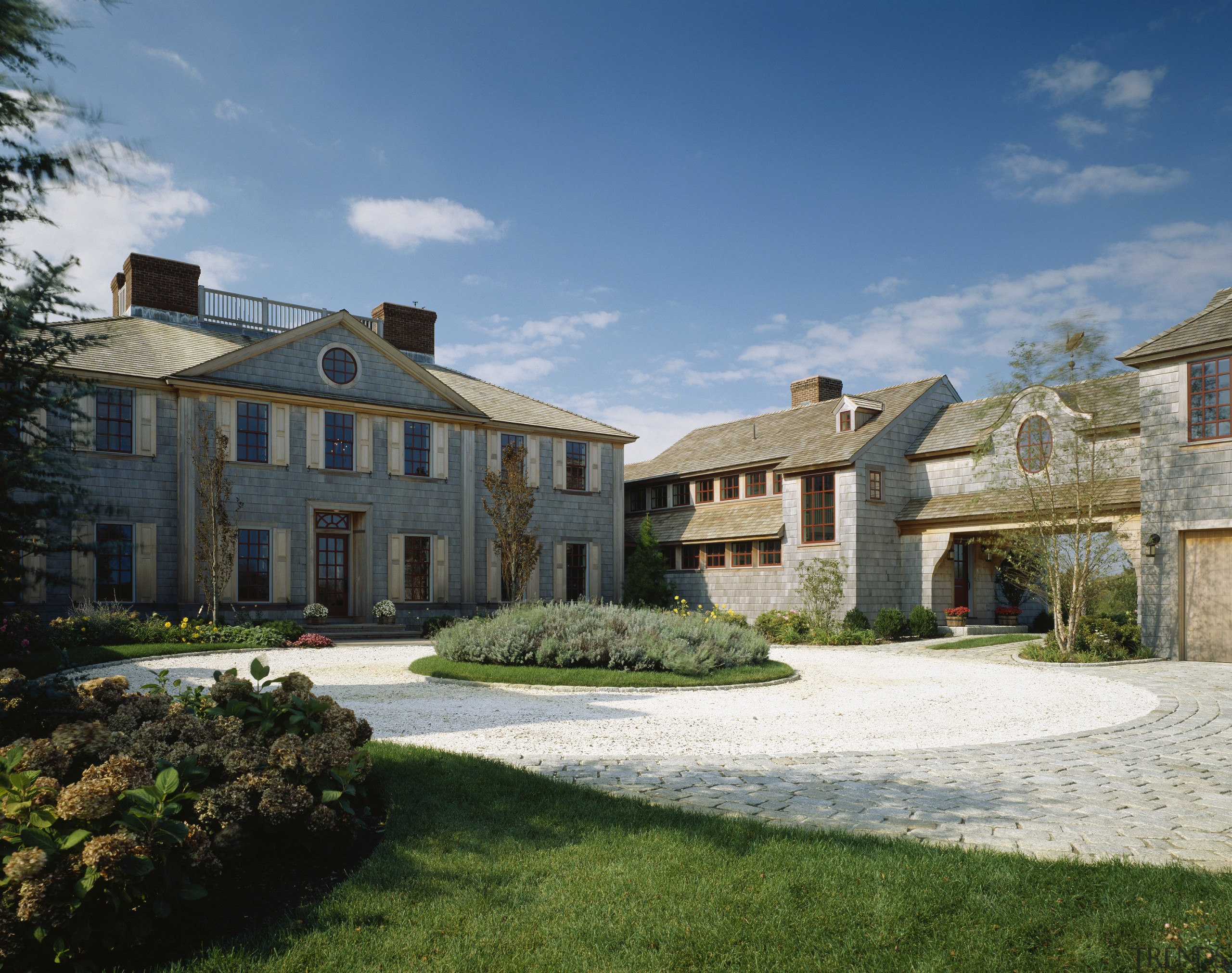 Exterior view of a large cottage with cedar cottage, estate, facade, farmhouse, home, house, mansion, property, real estate, residential area, sky, suburb, villa, teal