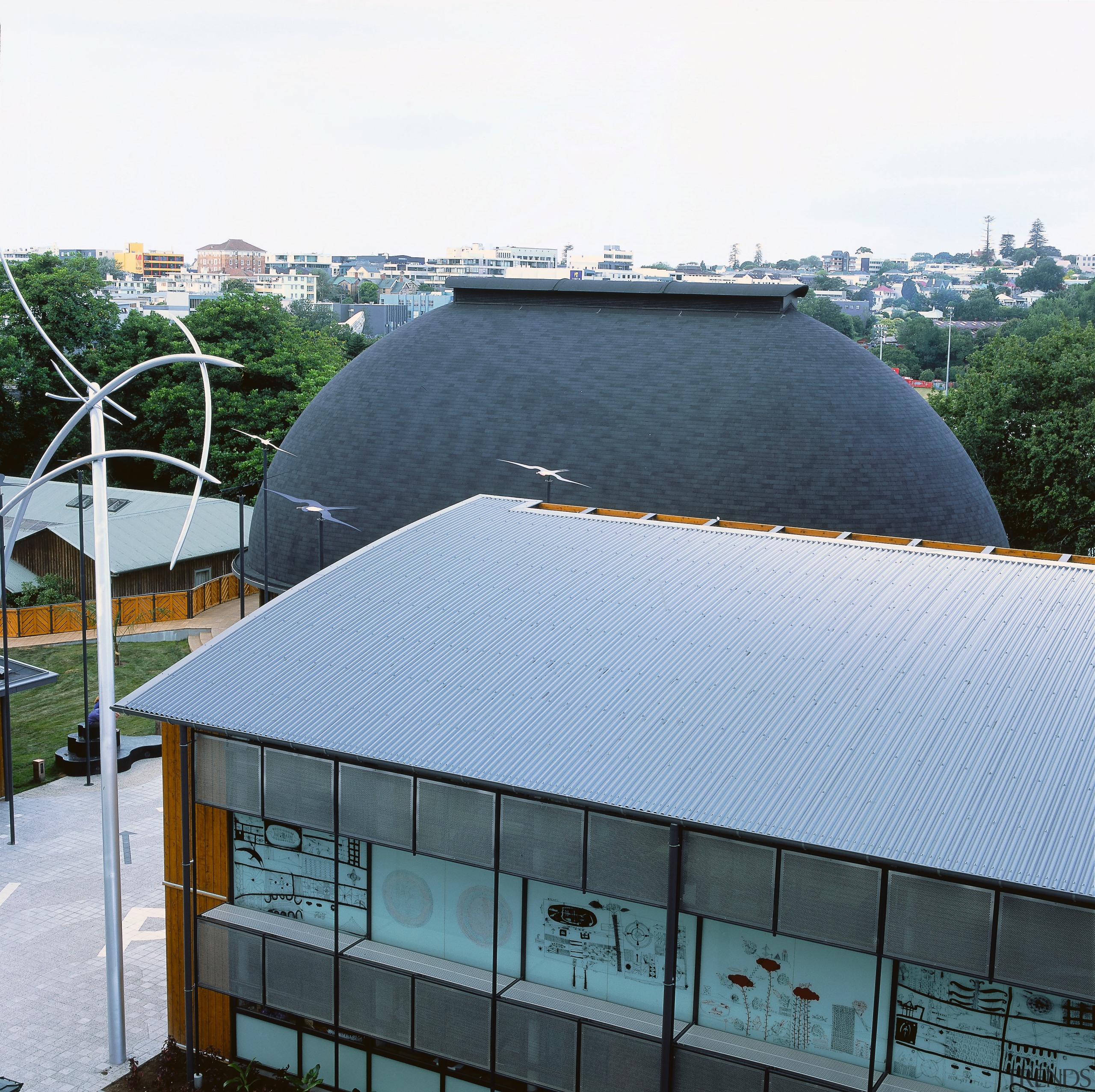 Grey ribbed roofing on building with round tiled architecture, building, daylighting, facade, roof, structure, white