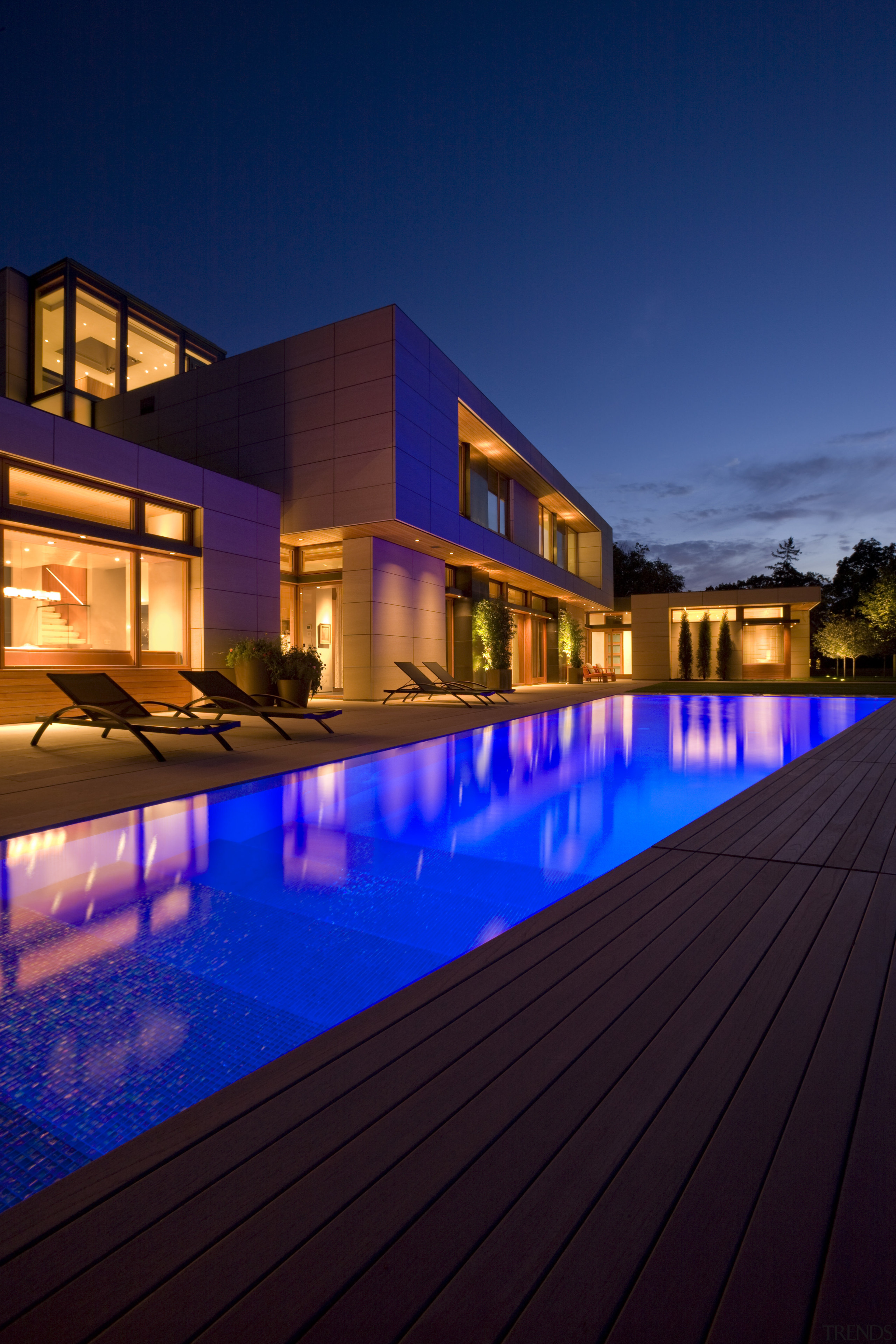 View of house with solid horizontal elements contrasted apartment, architecture, estate, evening, facade, home, hotel, house, lighting, mixed use, property, real estate, reflection, residential area, sky, swimming pool, blue
