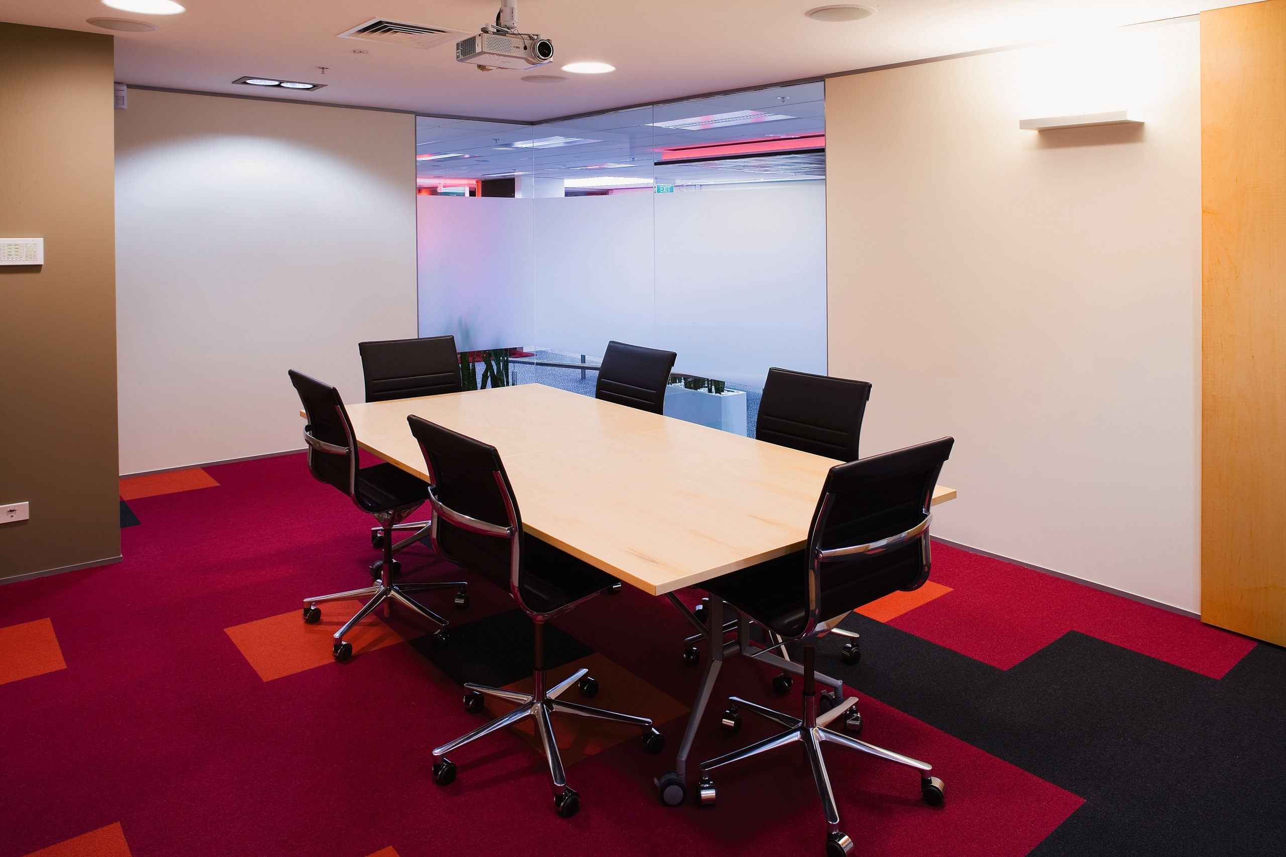 A view of the board room, red carpet, conference hall, desk, floor, flooring, furniture, interior design, office, real estate, table, gray