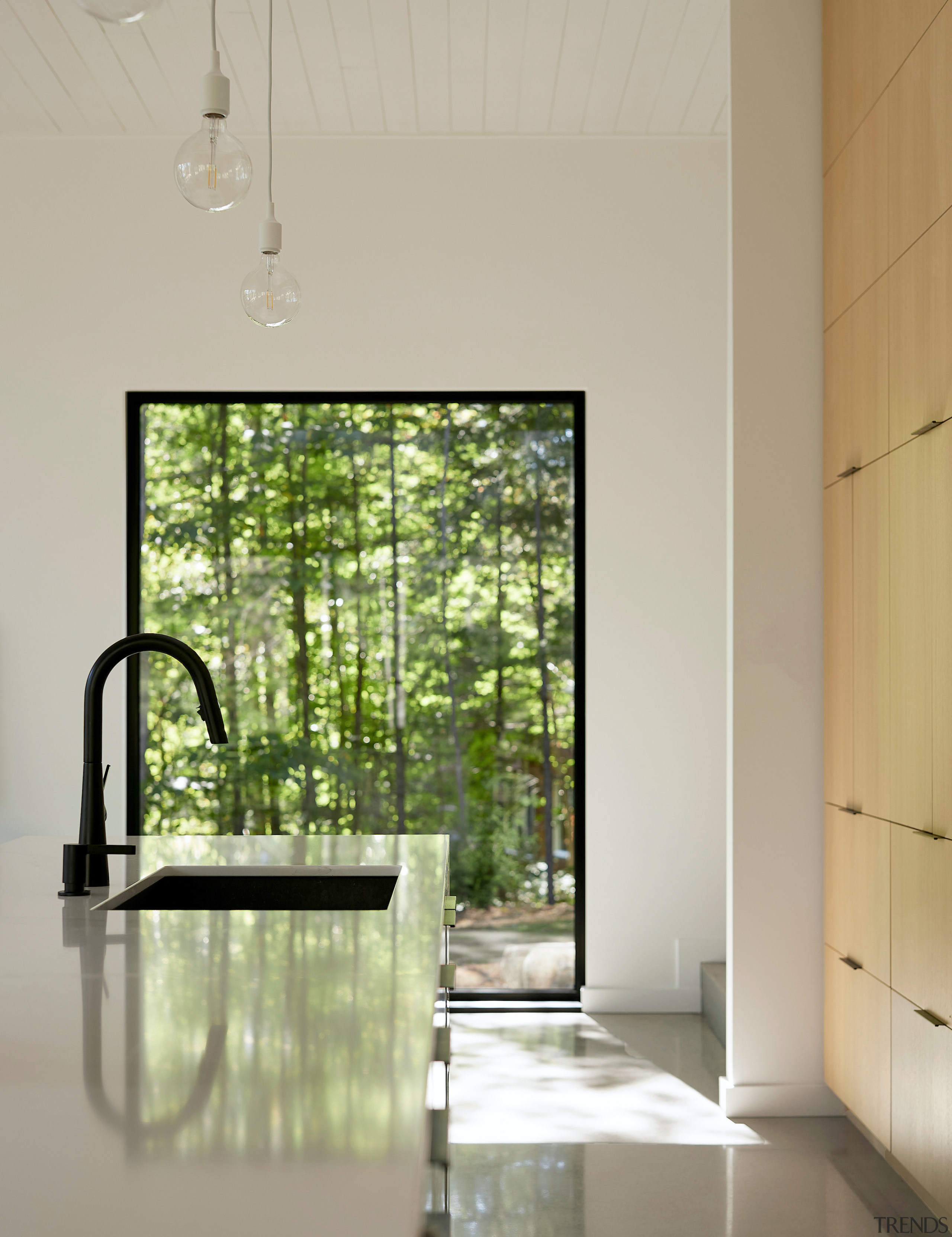 Floor-to-ceiling cabinetry backs the modern kitchen. 