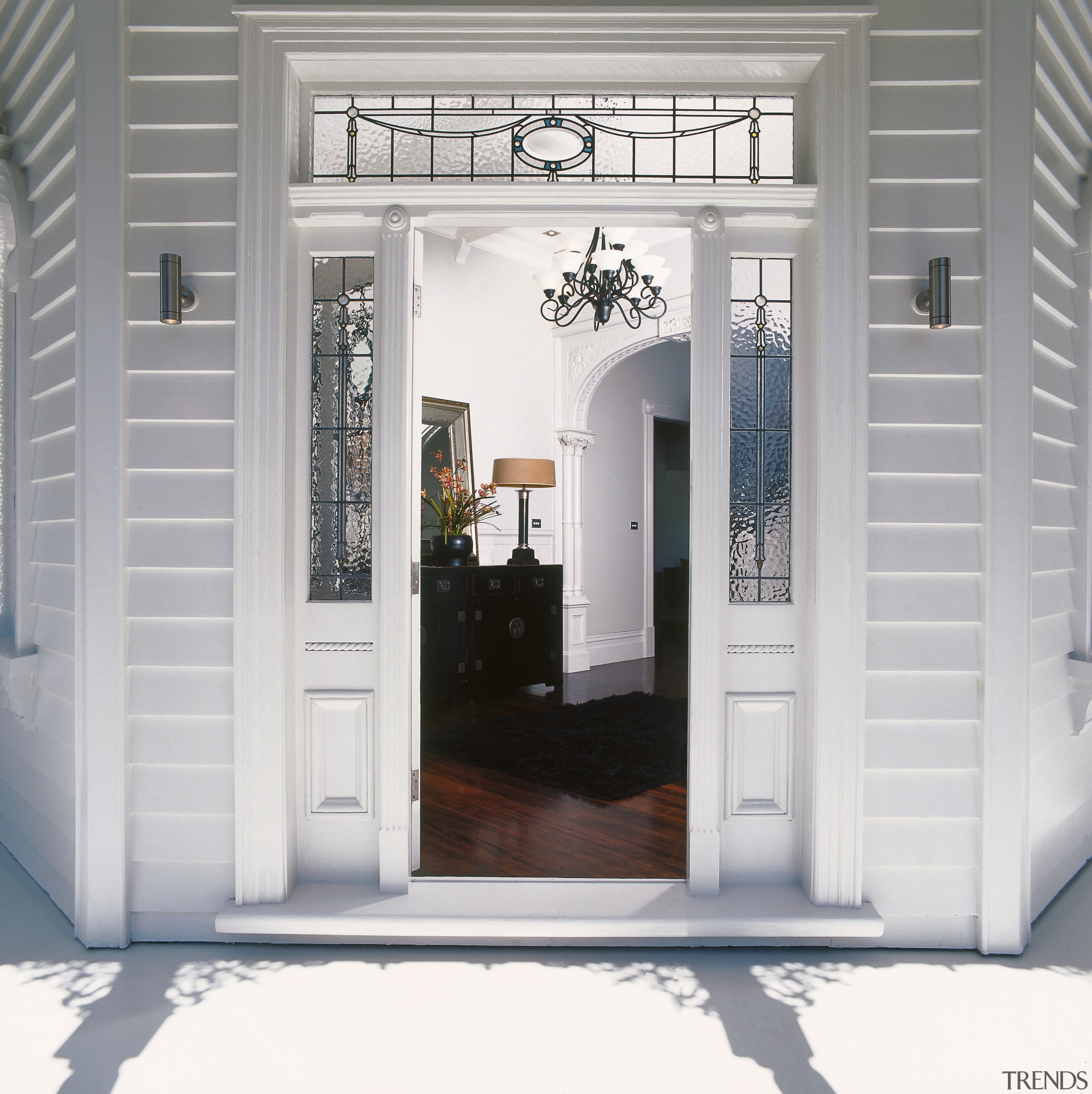 An exterior view of the entrance way to door, home, interior design, window, gray, white