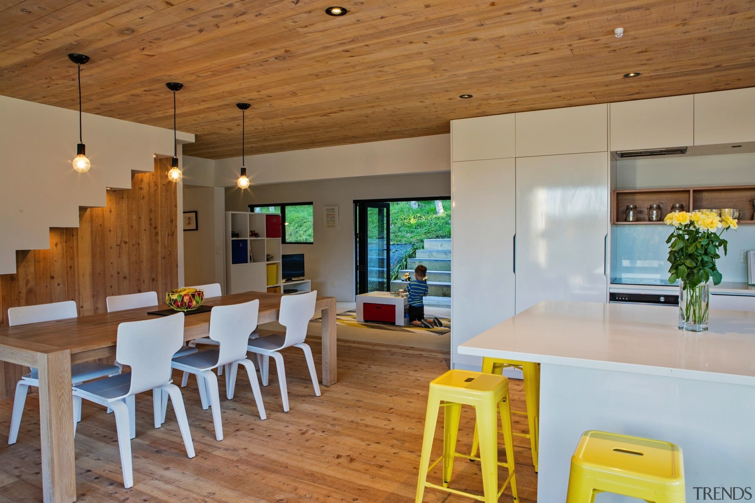 The living room features white cabinetry with a house, interior design, real estate, table, brown, gray