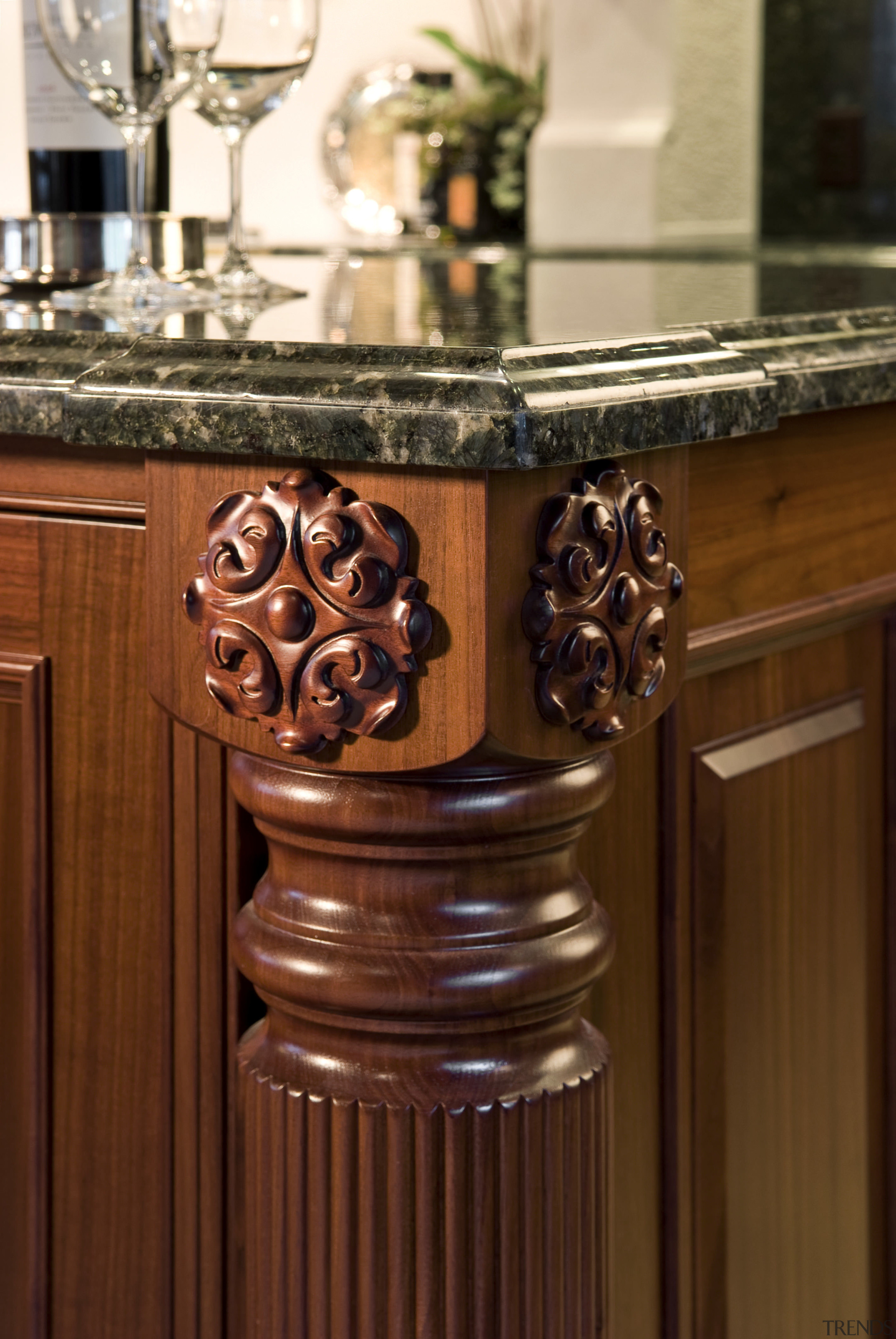 View of traditional trimmings on the kitchen island. cabinetry, countertop, flooring, furniture, hardwood, wood stain, brown