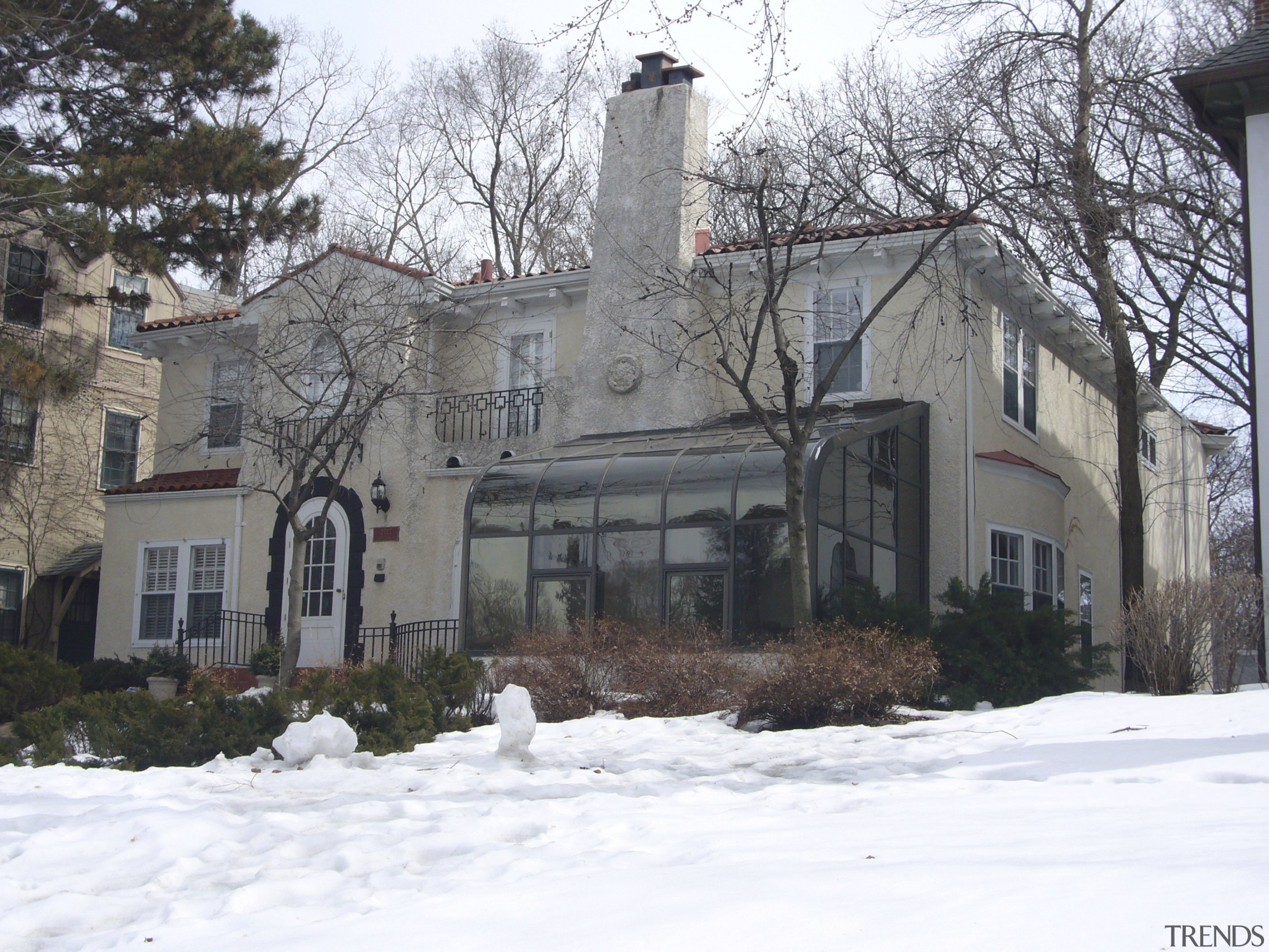 This house was remodeled by Tom Ellison of building, cottage, estate, facade, farmhouse, home, house, mansion, neighbourhood, property, real estate, residential area, roof, snow, suburb, tree, window, winter, white, gray