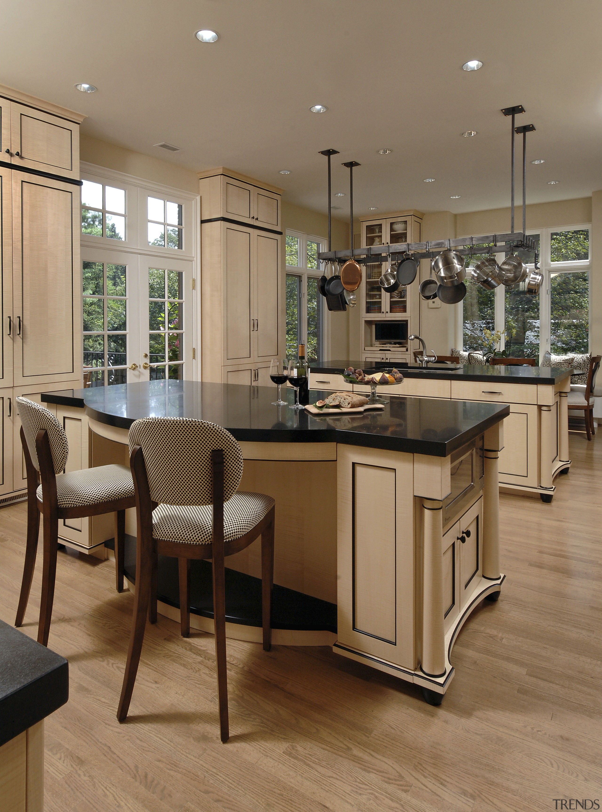 Designer Jennifer Gilmer, CKD, specified two islands for cabinetry, countertop, cuisine classique, floor, flooring, furniture, hardwood, interior design, kitchen, laminate flooring, room, table, wood, wood flooring, brown