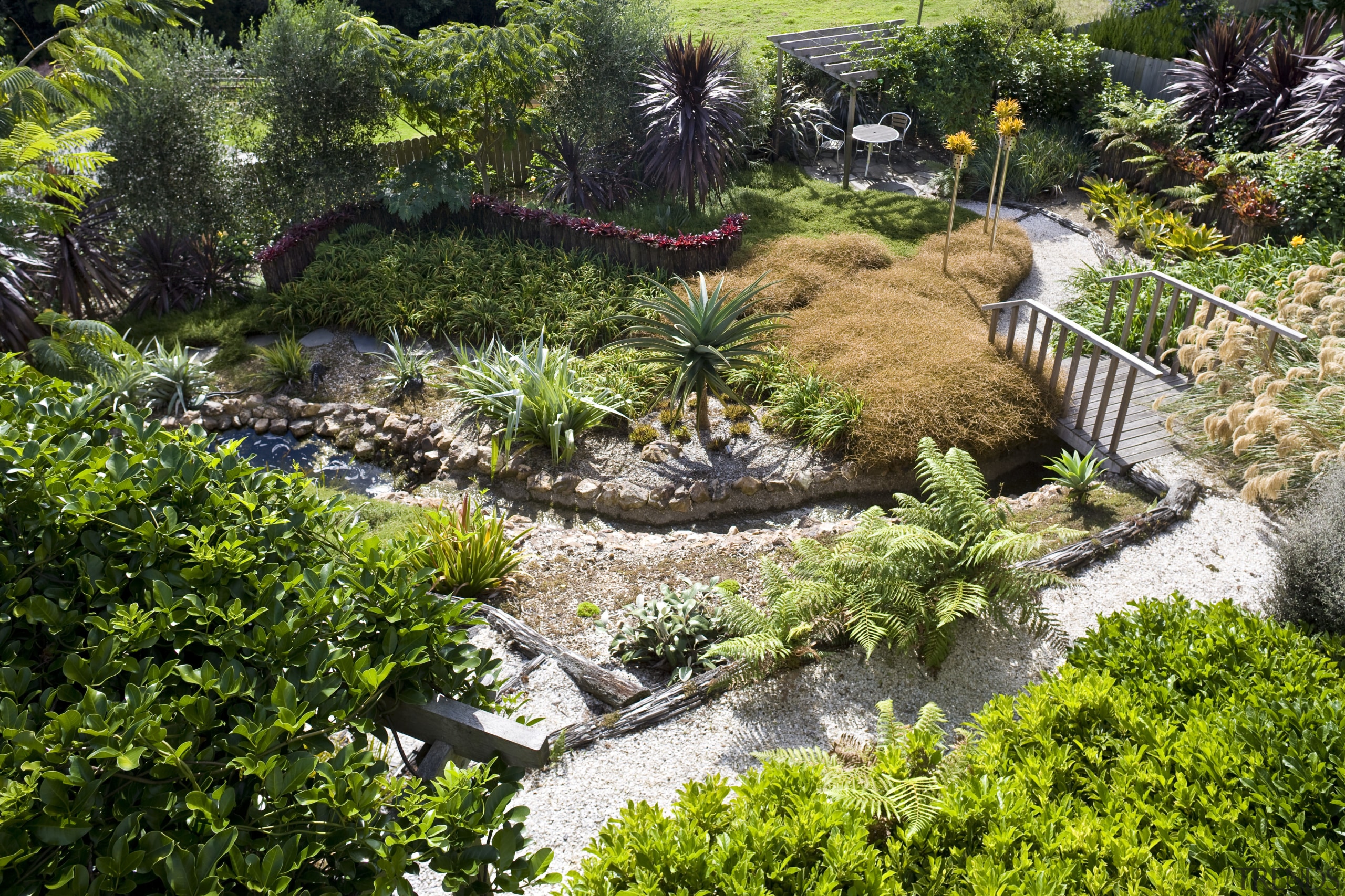 View of a landscaped garden which features a backyard, botanical garden, garden, grass, landscape, landscaping, plant, pond, tree, vegetation, walkway, water, watercourse, yard, green