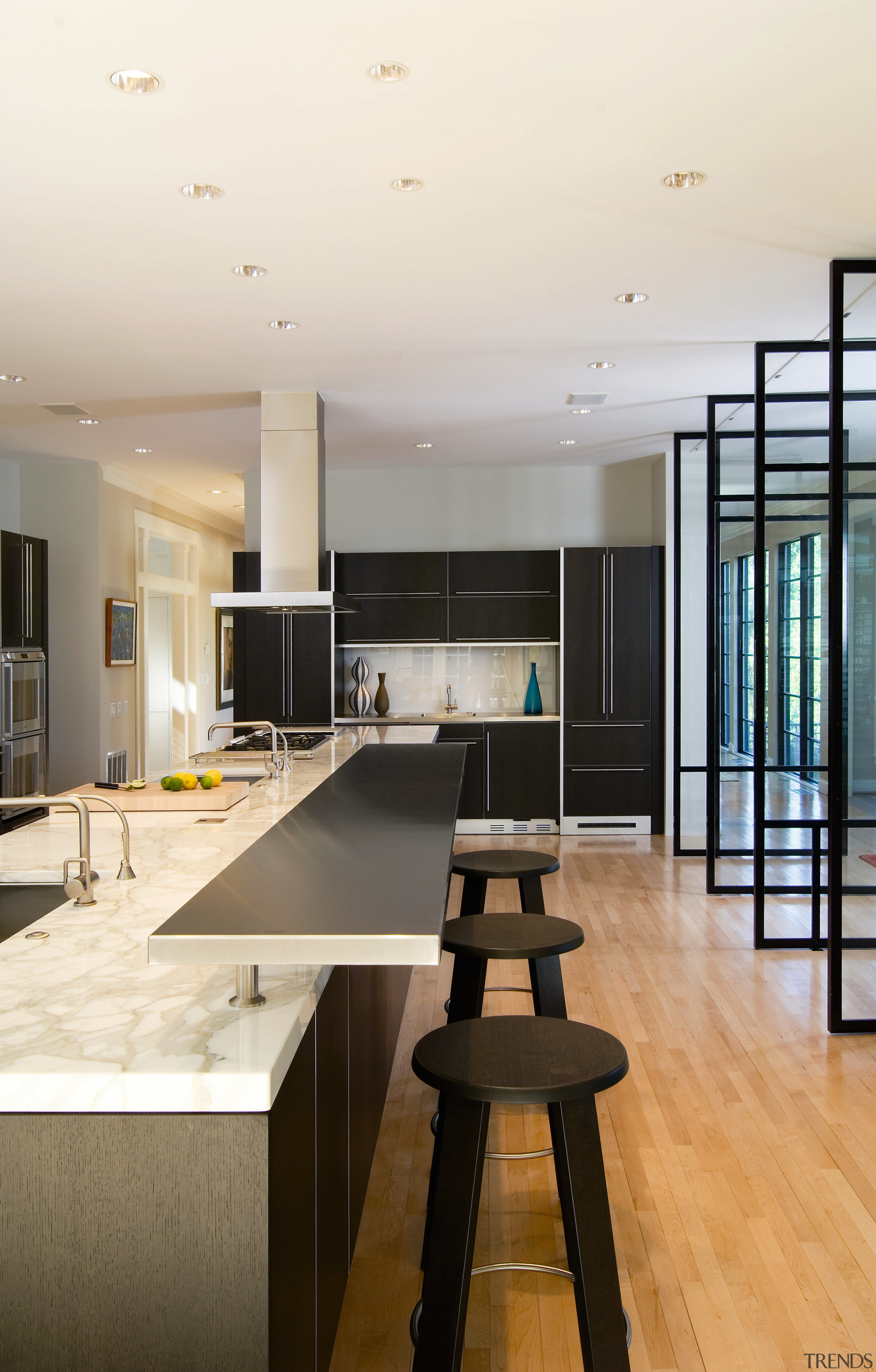 A view of this kitchen featuring maple flooring, architecture, ceiling, countertop, floor, flooring, interior design, kitchen, wood flooring, white