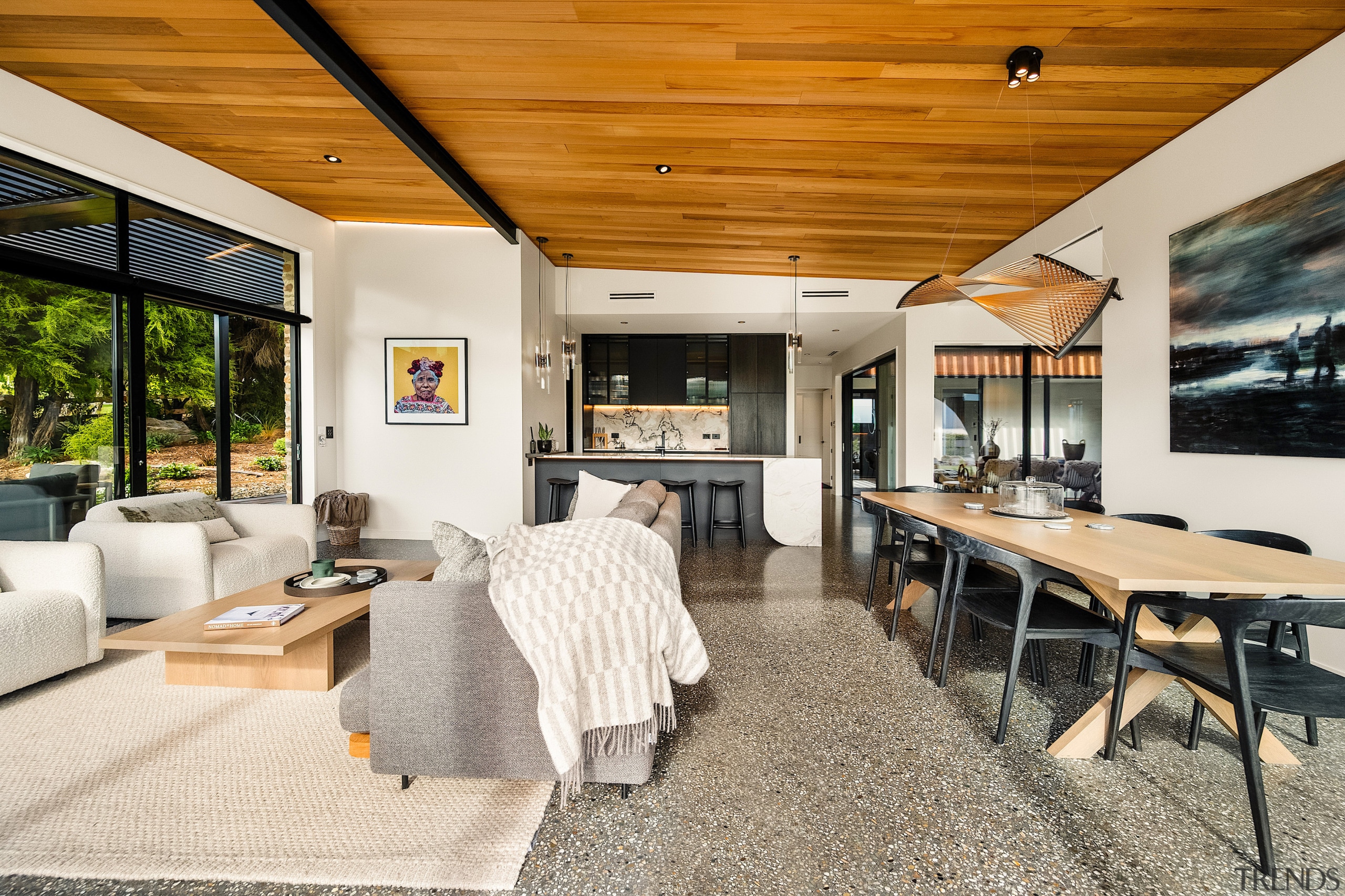 The kitchen's black cabinetry connects with the home's 