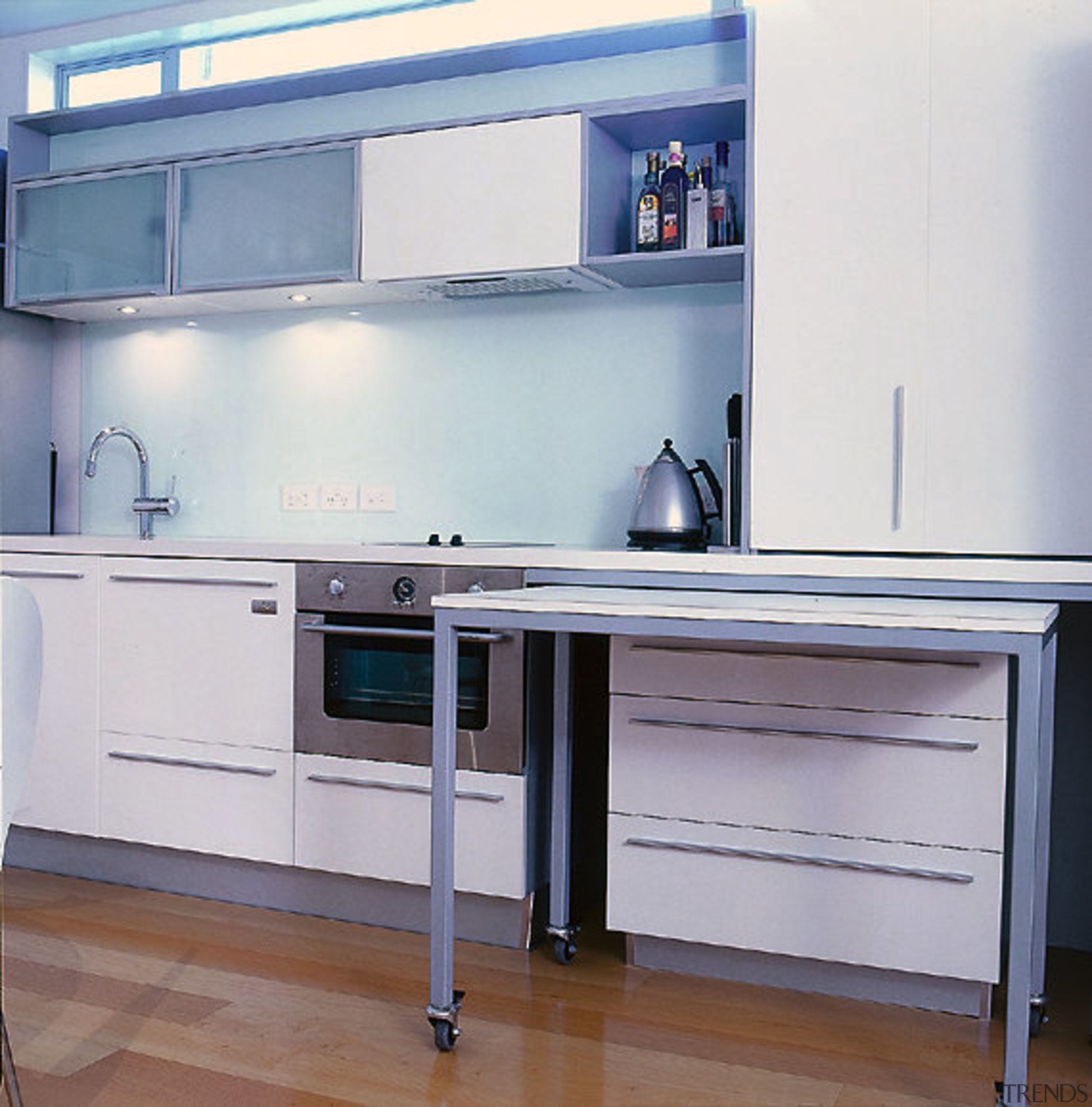 A pull-out mobile table features in the kitchen. cabinetry, countertop, furniture, home appliance, kitchen, major appliance, product, product design, gray