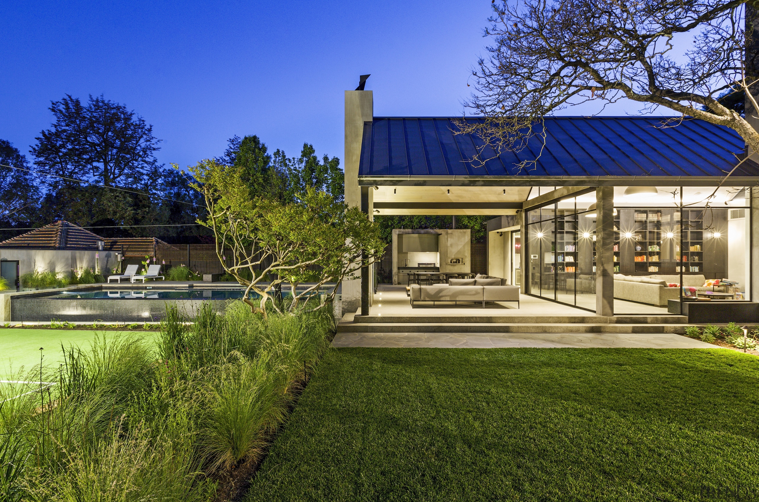 House and pool under an evening sky. - 