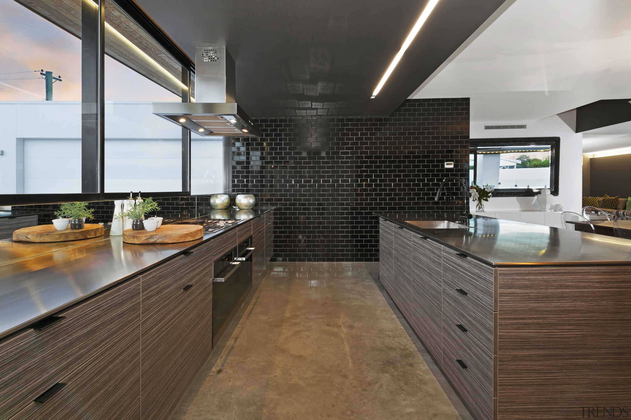 Black ceramic tiles create a feature wall in cabinetry, countertop, interior design, kitchen, real estate, brown, gray