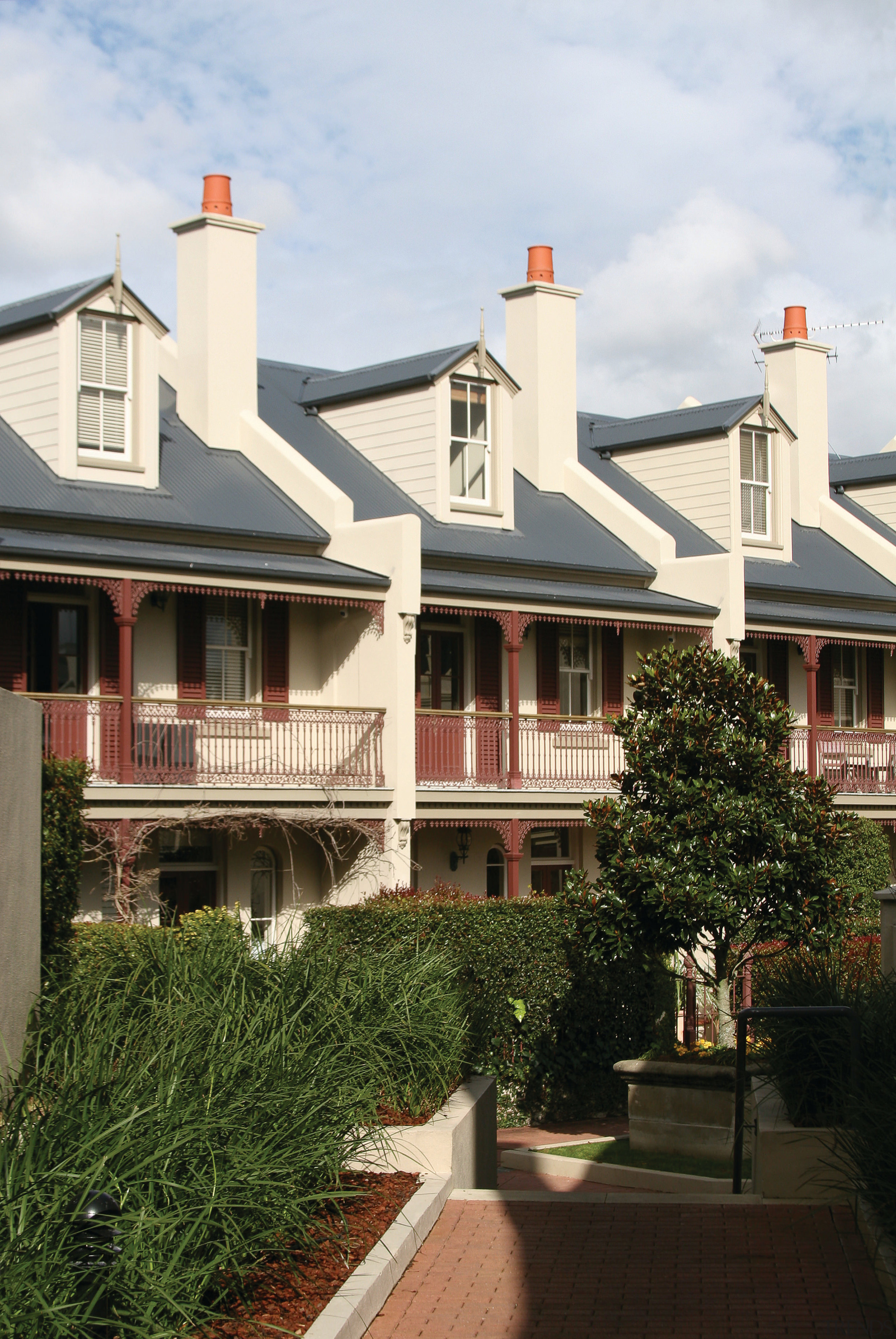 An exterior view of the domain terraces - architecture, building, cottage, estate, facade, historic house, home, house, mansion, neighbourhood, outdoor structure, property, real estate, residential area, roof, siding, suburb, tree, window, white