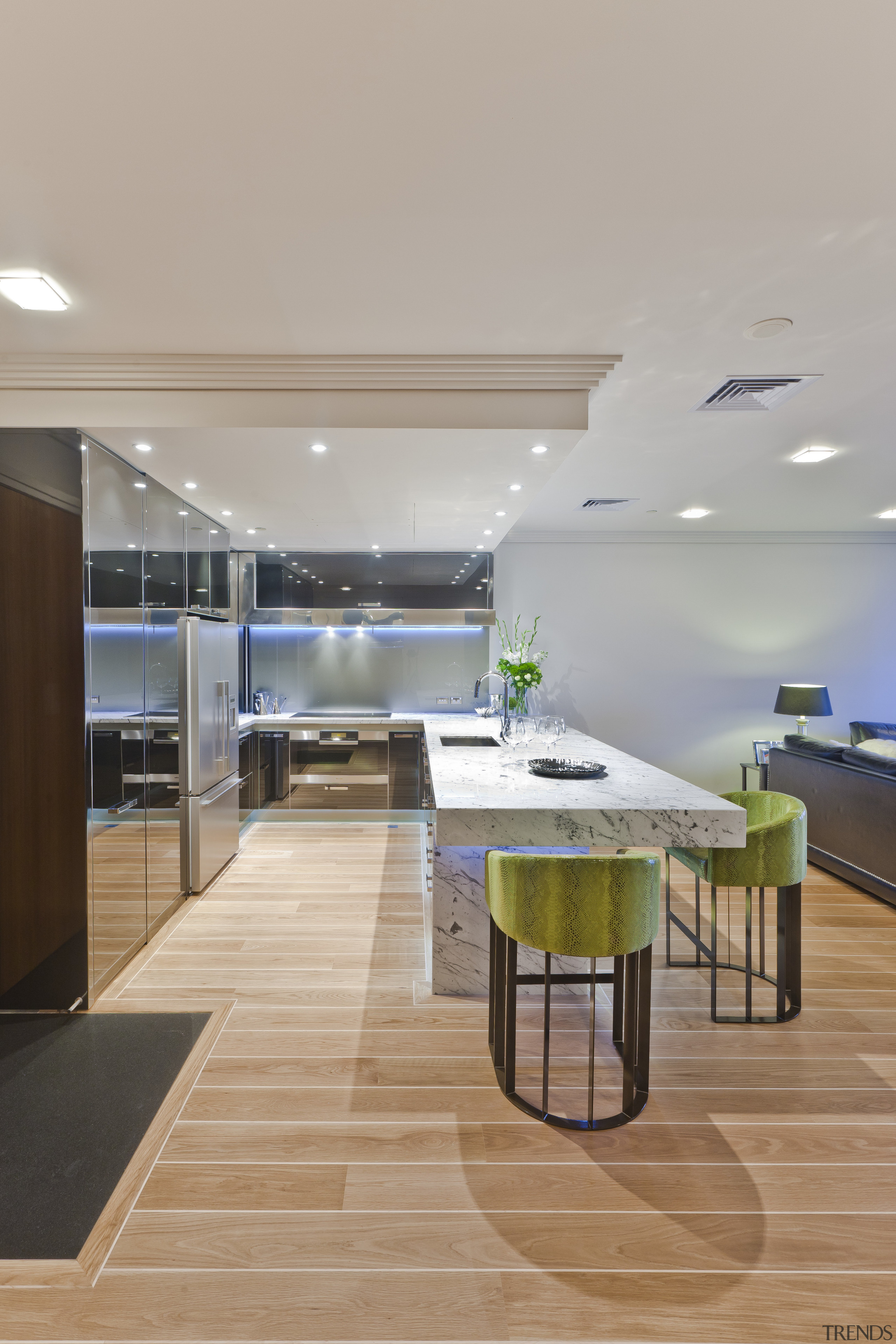 View of apartment kitchen with black glass cabinetry, architecture, ceiling, floor, flooring, hardwood, interior design, kitchen, laminate flooring, table, wood flooring, gray