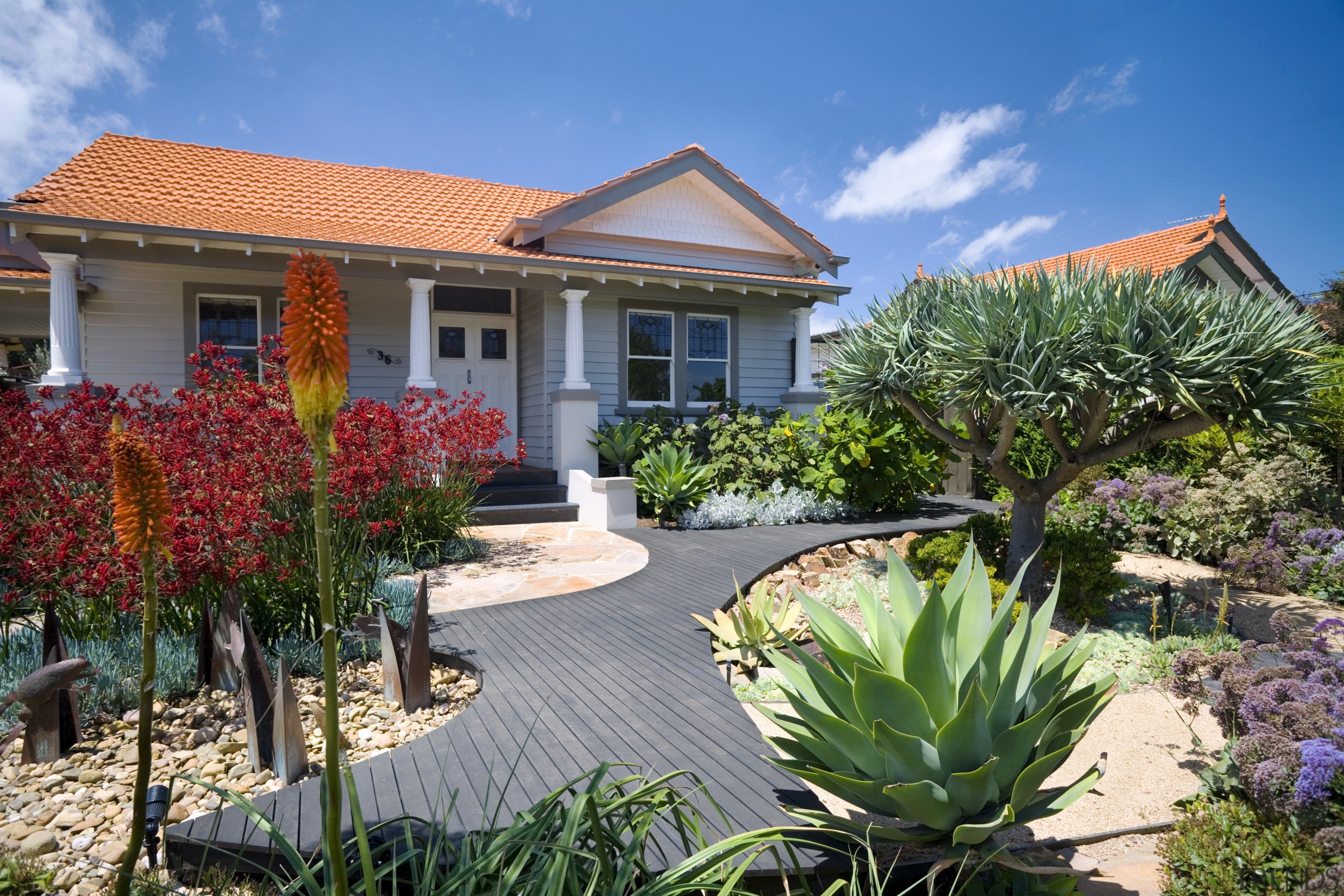 An exterior view of the entrance way to botanical garden, cottage, estate, garden, home, house, landscaping, plant, property, real estate, resort, villa