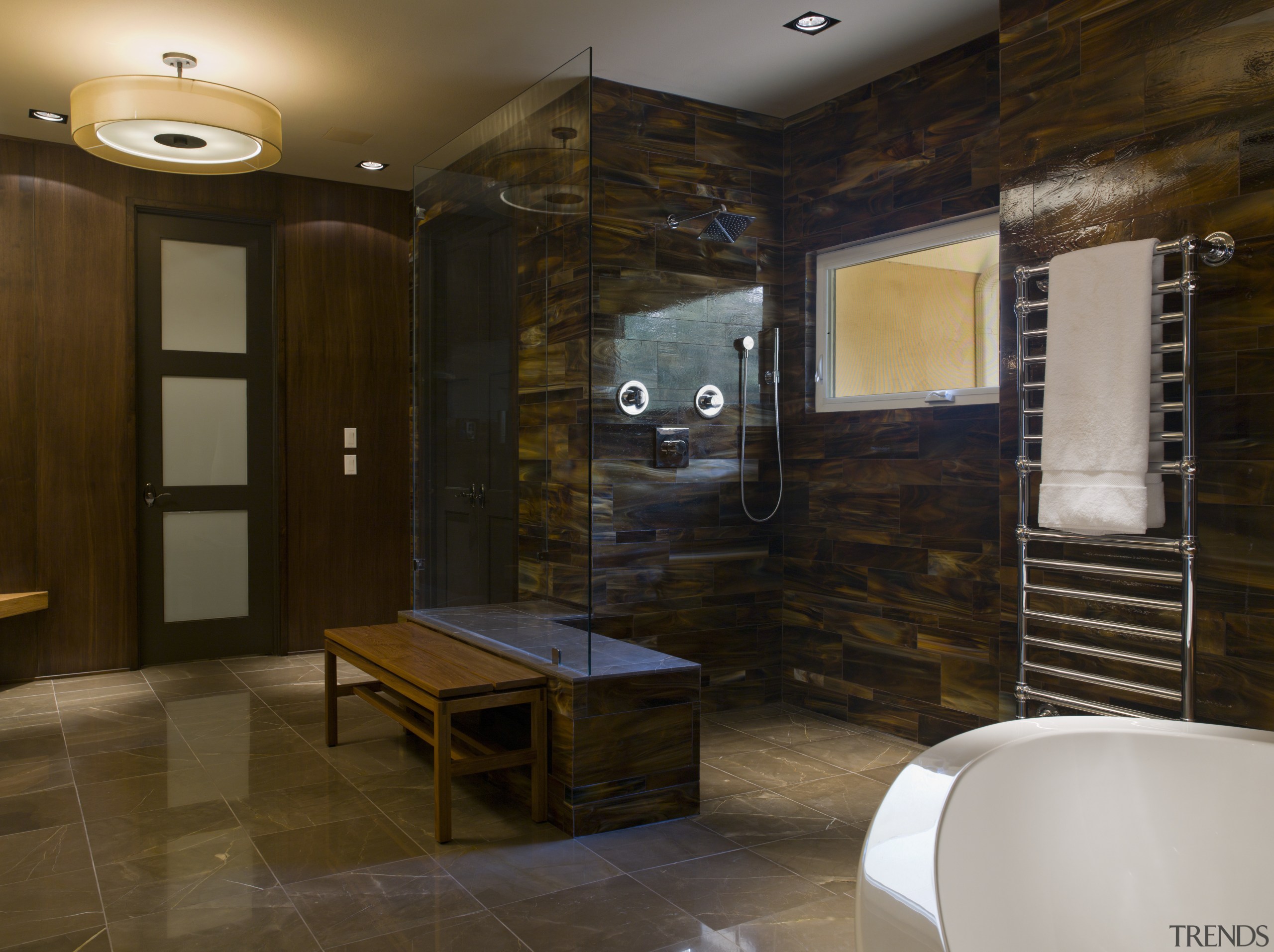 This walk-in shower is tiled in tortoiseshell glass. bathroom, ceiling, floor, flooring, interior design, lobby, room, wall, brown, black