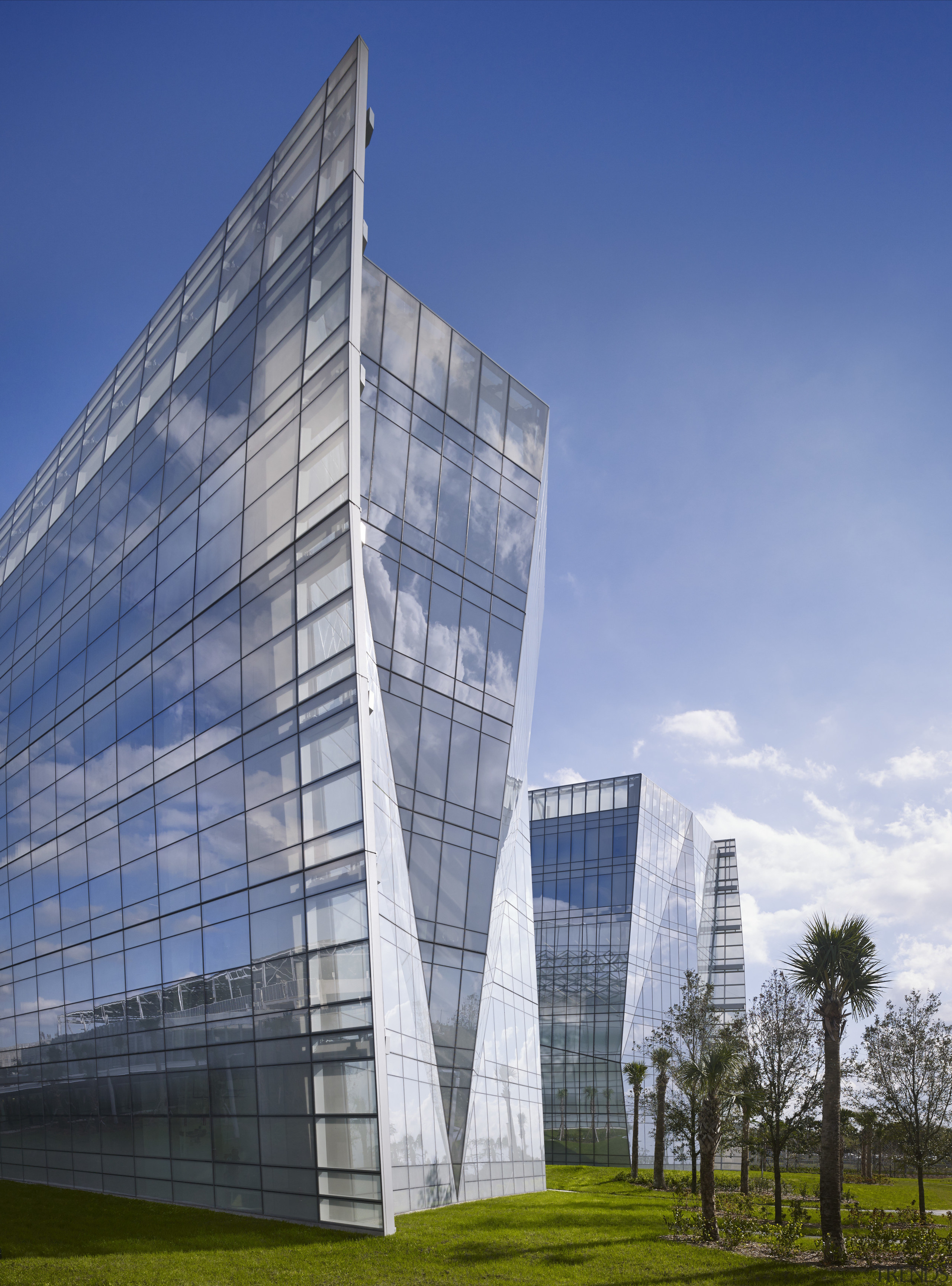 The new FBI headquarters is a picture of architecture, building, commercial building, condominium, corporate headquarters, daytime, facade, grass, headquarters, landmark, metropolis, metropolitan area, mixed use, real estate, sky, skyscraper, tower, tower block, urban area, blue, gray