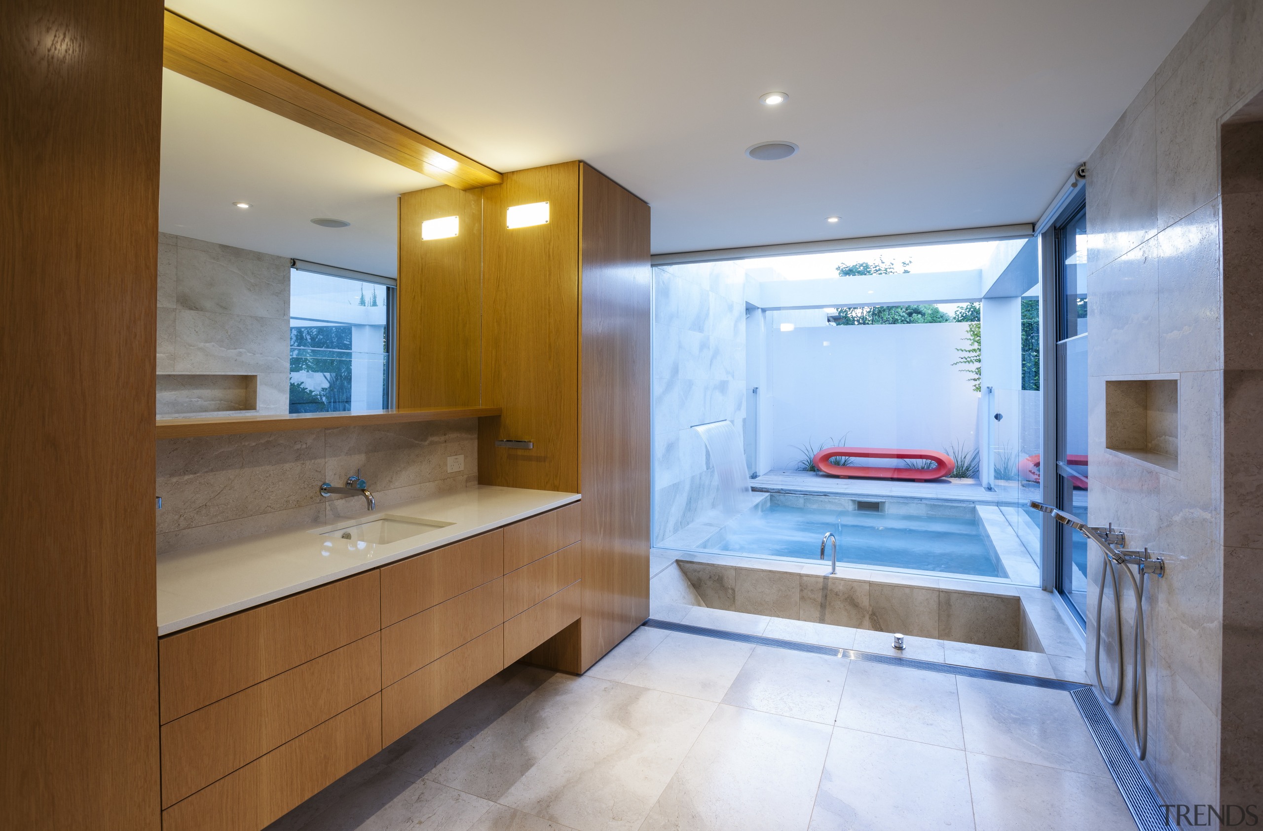 A continuity of materials helps to unify the bathroom, interior design, real estate, room, gray, brown