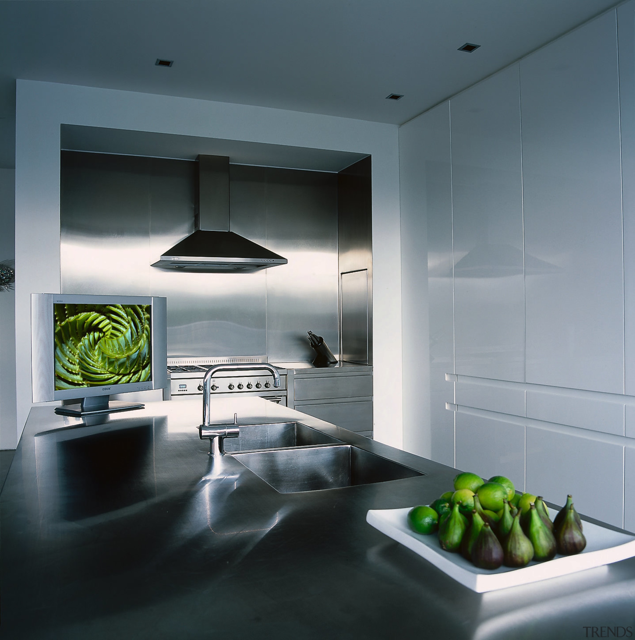 A photograph of a kitchen featuring a flat-screen architecture, ceiling, countertop, interior design, kitchen, product design, gray, black