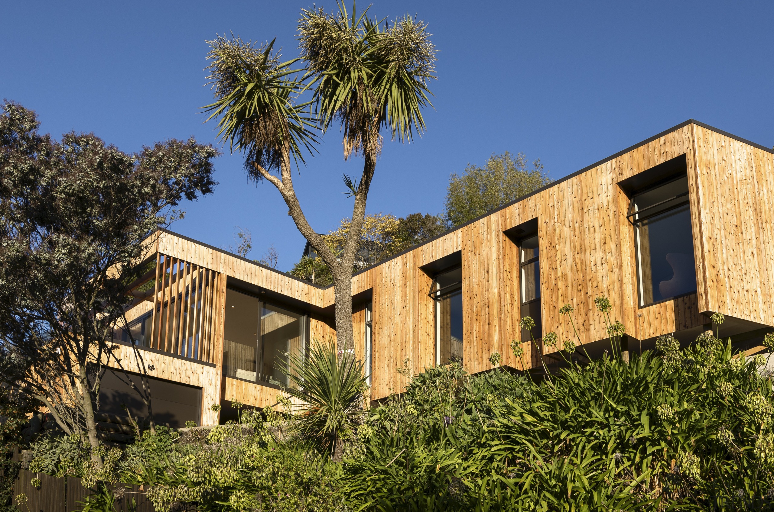 The owner of this home on a lower architecture, arecales, cottage, estate, facade, home, house, palm tree, property, real estate, sky, villa, brown, blue