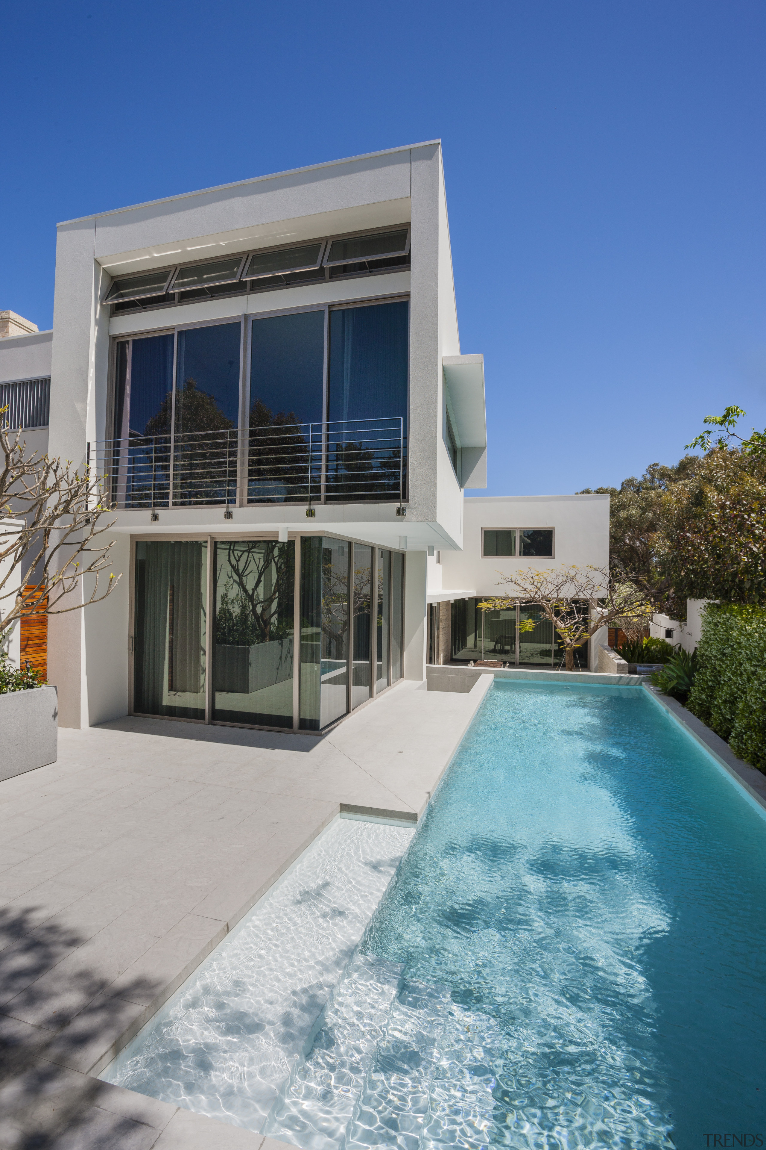 The silver travertine facade provides a solid barrier apartment, architecture, building, condominium, estate, facade, home, house, property, real estate, residential area, sky, swimming pool, villa, gray