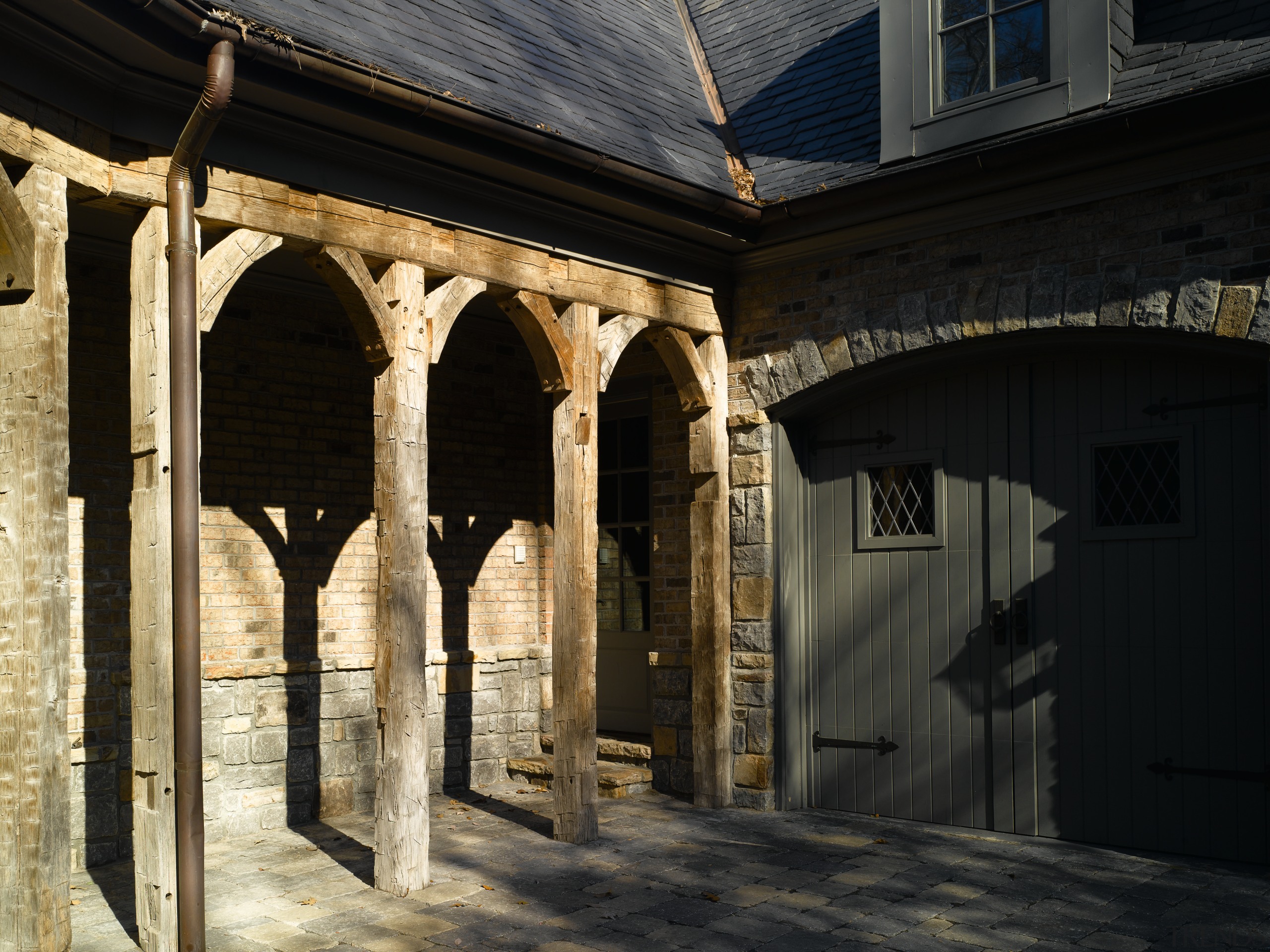 Exterior view of stone clad home with antique arch, architecture, building, facade, structure, window, black