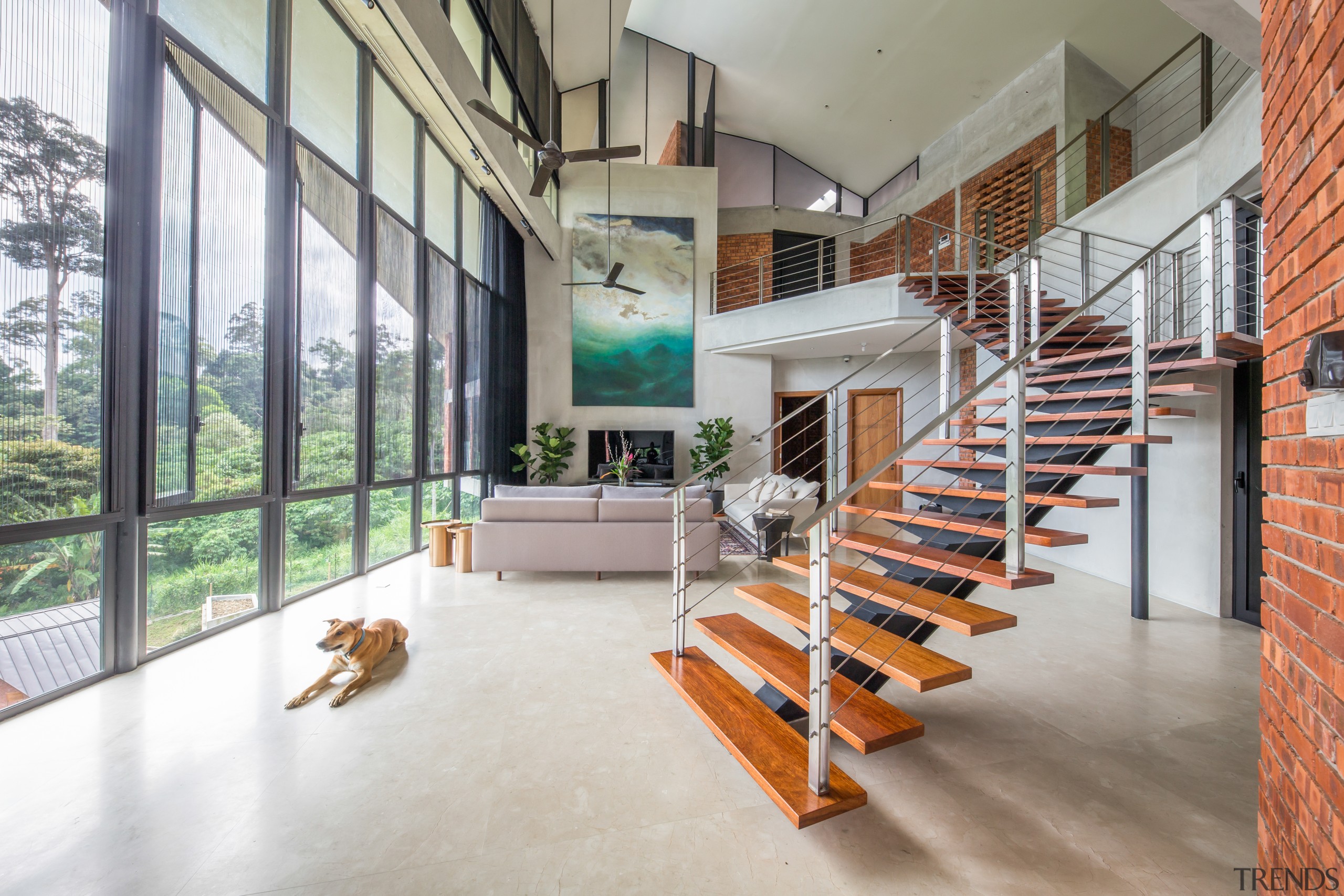 The living room combines a soaring ceiling with architecture, building, daylighting, floor, flooring, handrail, home, house, interior design, loft, property, real estate, residential area, room, stairs, wood, gray, white