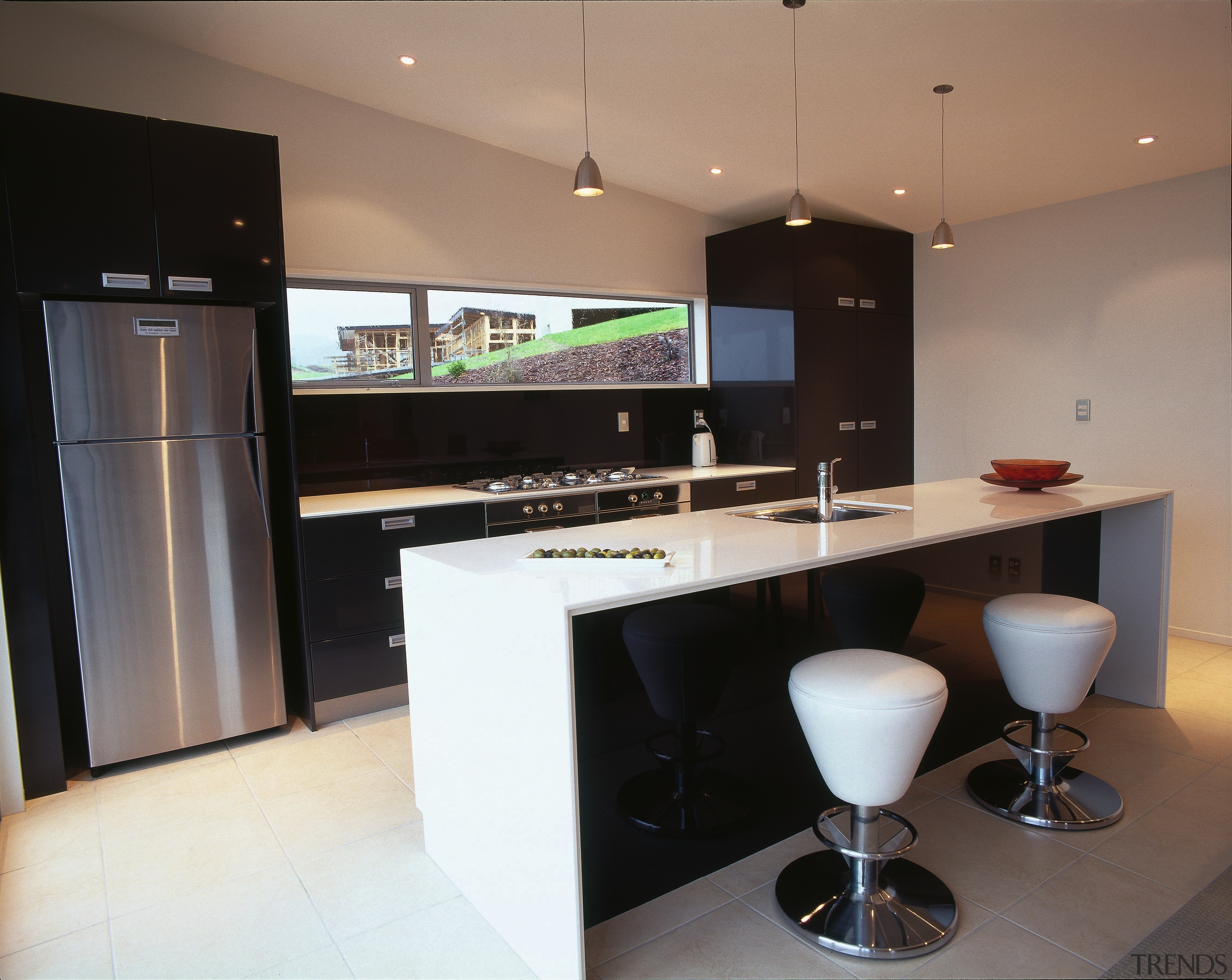 Kitchen with black and white cabinetry, gas cooktop, countertop, interior design, kitchen, real estate, black